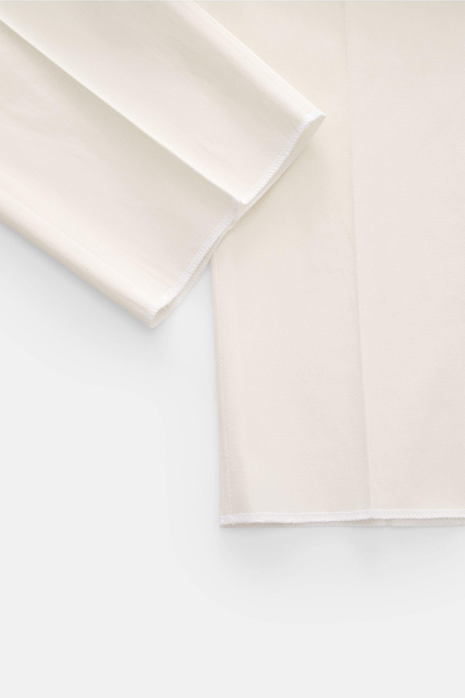 Close-up of the hem and lower leg area of PT Torino Chinos 'Union Fit' cream, photographed from the front left side, showing the open length and soft twill cotton-silk blend fabric with slight stretch for extra freedom of movement, regular fit, tapered cu