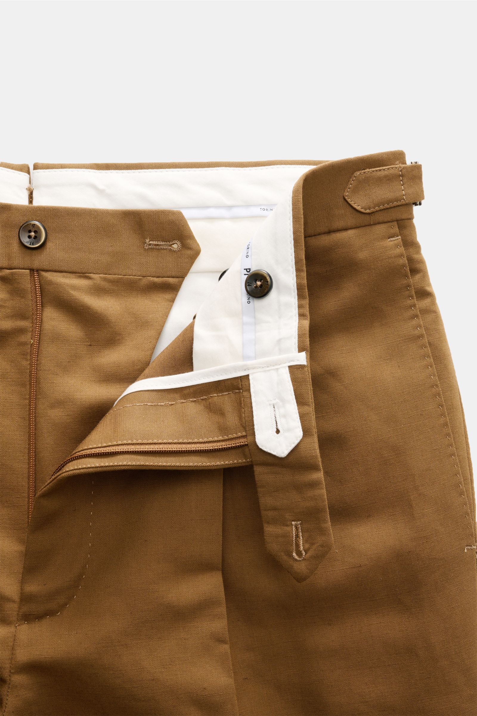 Close-up front view of PT Torino Trousers 'Gentleman Fit' brown showing open zip, buttons, side adjuster, and inner white lining made from linen and cotton blend.