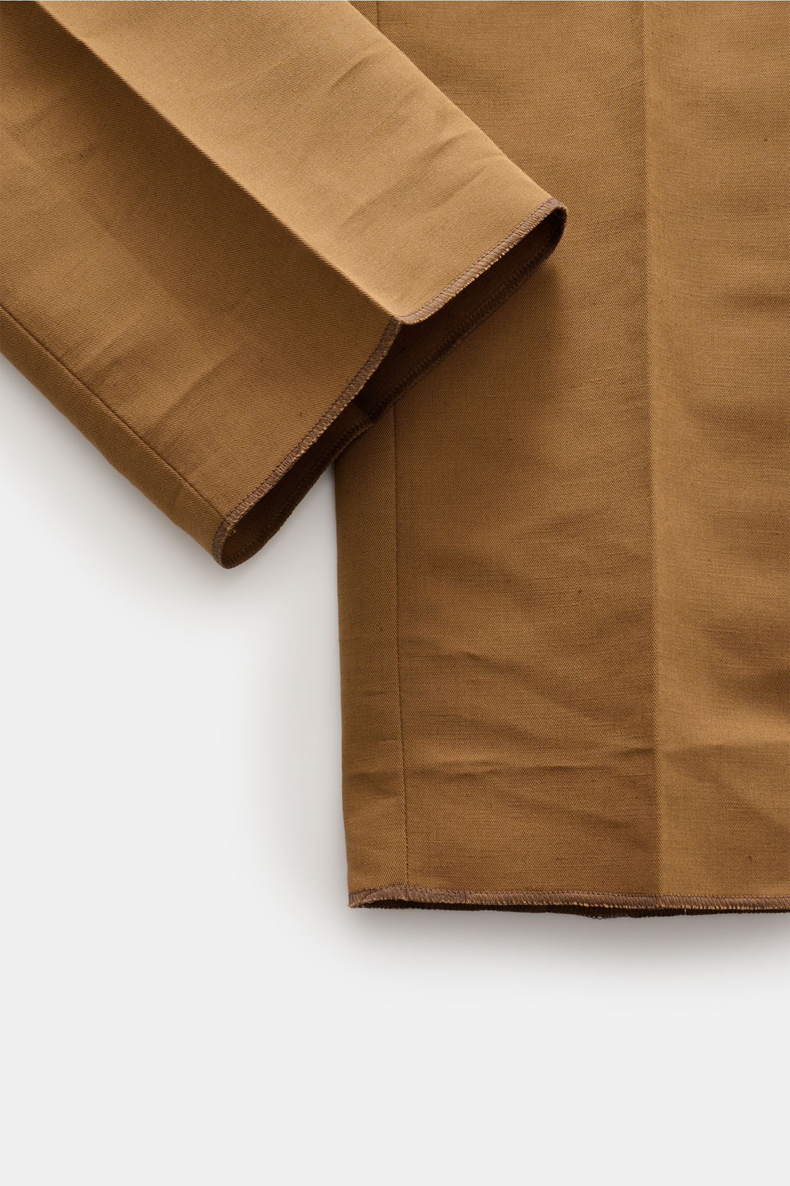 PT Torino Trousers 'Gentleman Fit' brown shown from a close-up side angle, highlighting the slim, tapered cut and linen-cotton fabric texture.