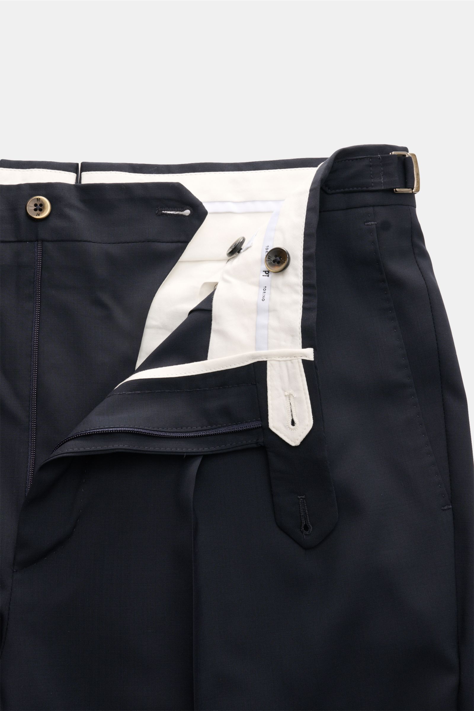 Close-up front view of PT Torino Wool trousers 'Gentleman Fit' navy, showcasing lightweight Super 130'S virgin wool fabric, slim taper, zip, buttons, extended tab, and side adjuster. For the exclusive trousers 'Gentleman Fit', PT TORINO has chosen virgin 
