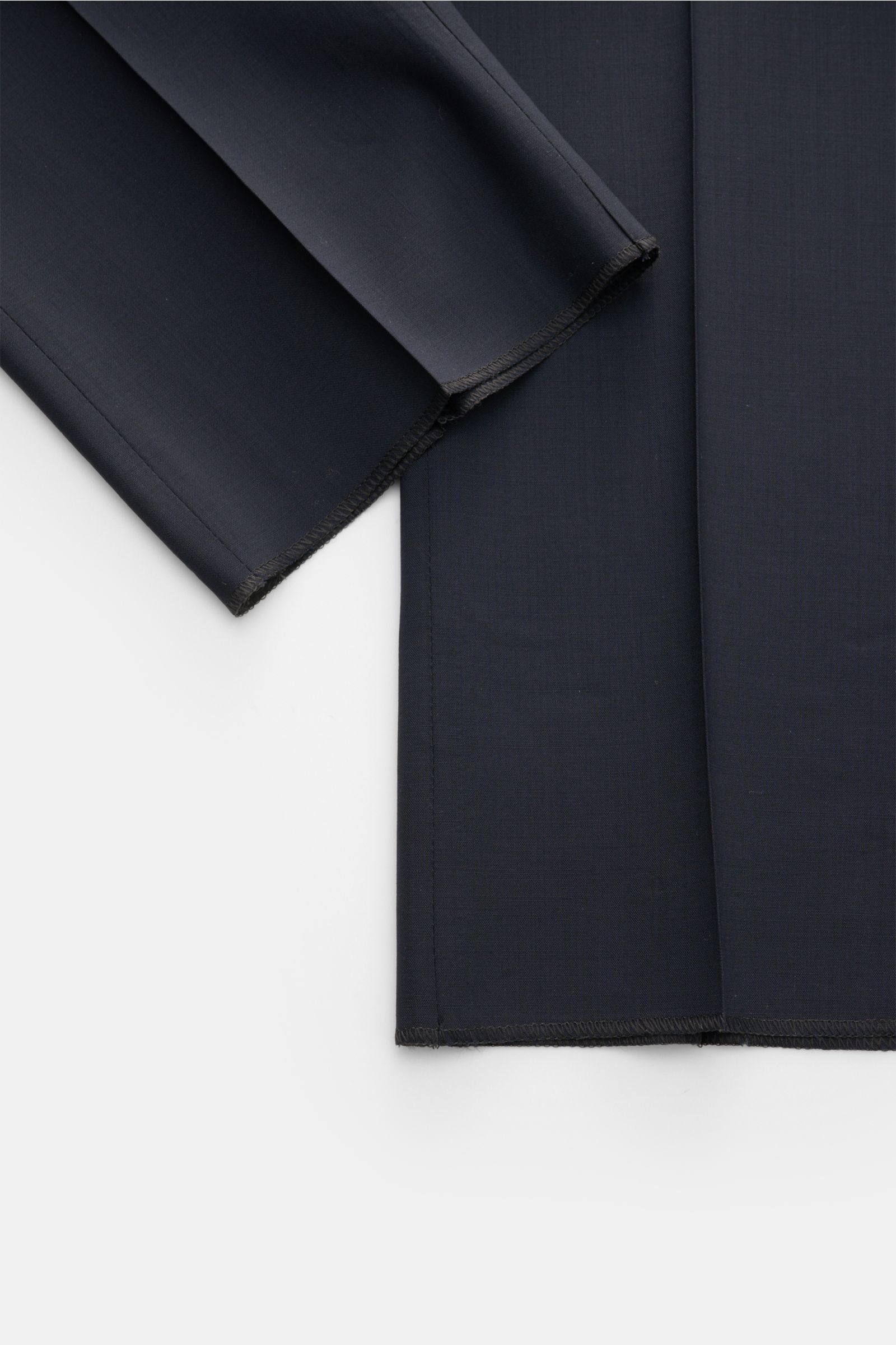 Close-up top-down view of navy PT Torino Wool trousers 'Gentleman Fit' showing the lightweight Super 130'S virgin wool fabric with tapered cut and open length hems. 

Description: For the exclusive trousers 'Gentleman Fit', PT TORINO has chosen virgin woo