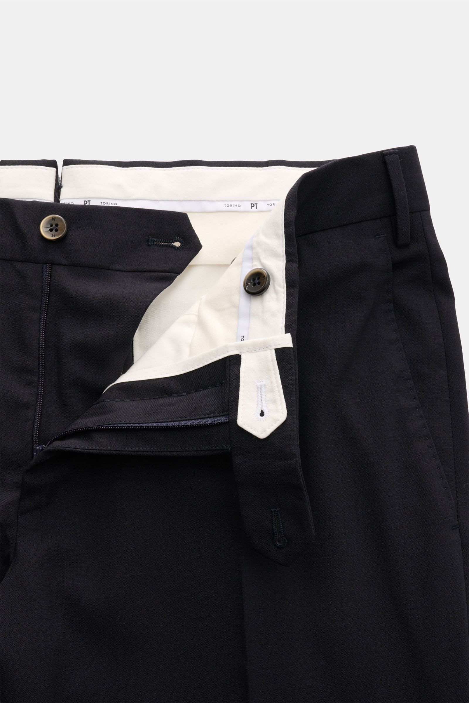 Close-up front view of PT Torino Wool trousers 'Slim Fit' navy, showing zip, buttons, and waistband details in fine virgin wool fabric.

For these exclusive trousers, PT TORINO has chosen the finest virgin wool that emphasises the slim cut silhouette with