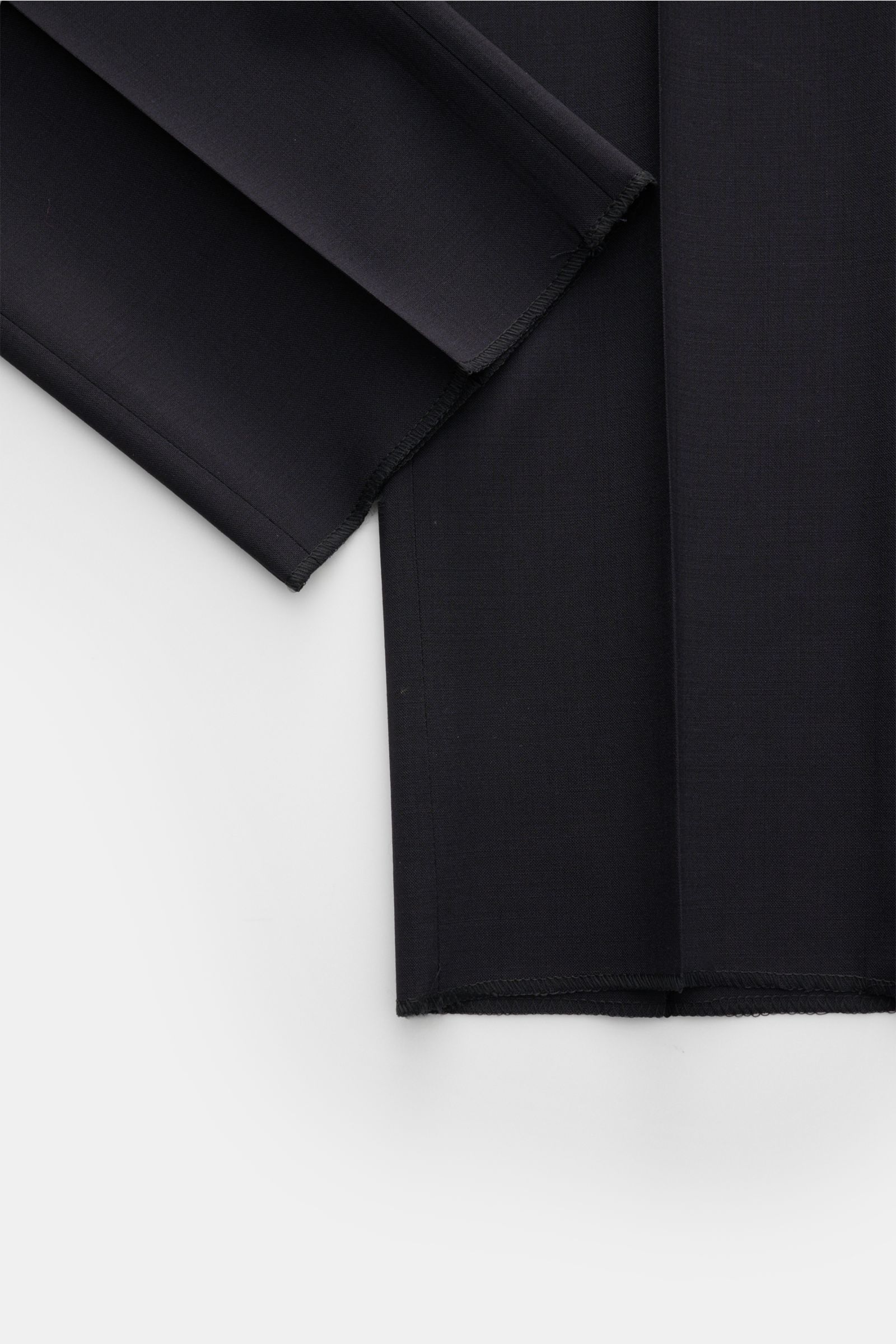 Close-up top-down view of PT Torino Wool trousers 'Slim Fit' navy showing the fine virgin wool fabric and open length hems.

Description: For these exclusive trousers, PT TORINO has chosen the finest virgin wool that emphasises the slim cut silhouette 