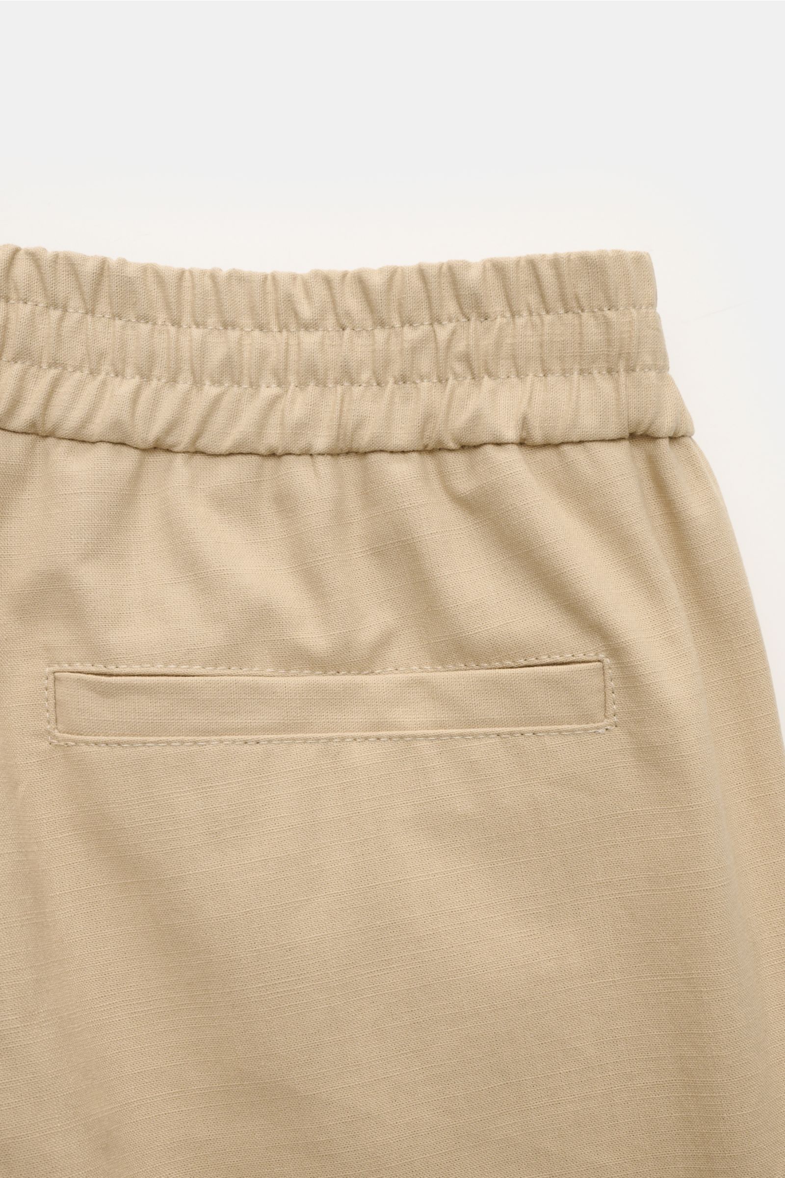 Close-up of A.P.C. Joggpants 'Pieter' beige, showing elastic waistband, rear welt pocket, pure cotton fabric.