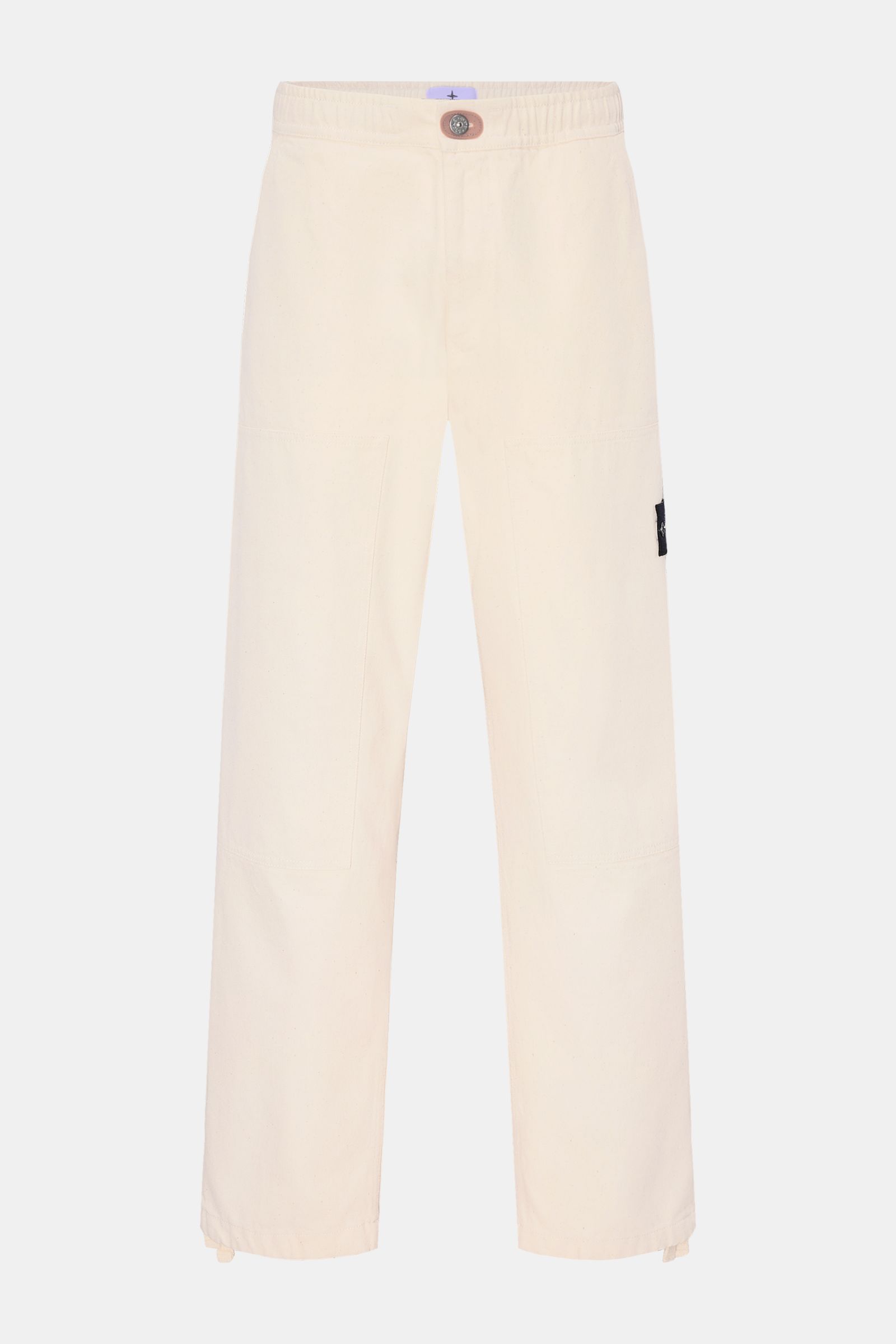Stone Island Jogger pants 'Raw Beauty' cream shown from the front on a plain background, made of pure cotton twill with a robust feel. These robust jogger pants called 'Raw Beauty' by STONE ISLAND are made of distinctive pure cotton twill in workwear styl