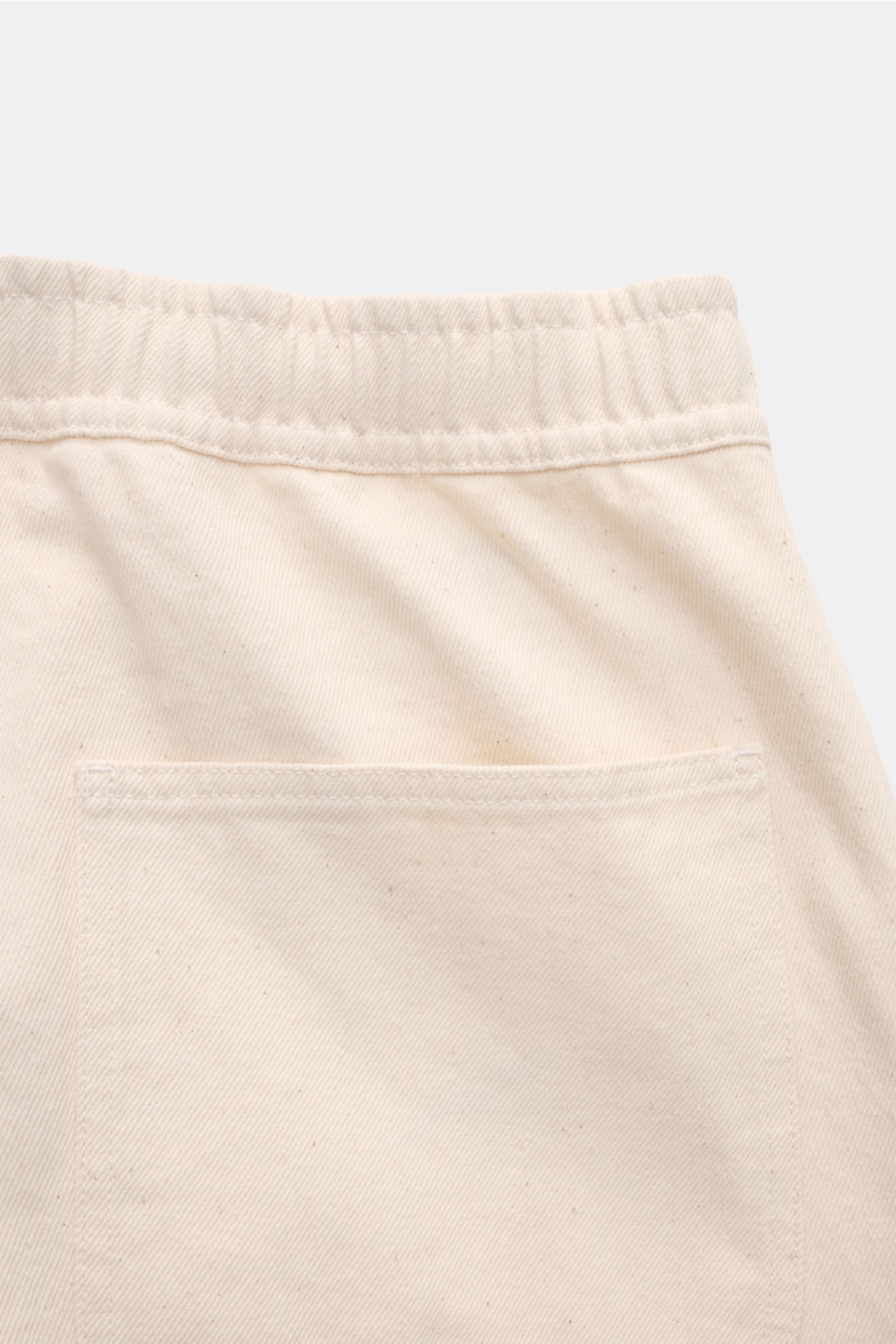Close-up rear view of Stone Island Jogger pants 'Raw Beauty' cream showing elastic waistband and patch back pocket in robust pure cotton twill.

Description: These robust jogger pants called 'Raw Beauty' by STONE ISLAND are made of distinctive pure cot