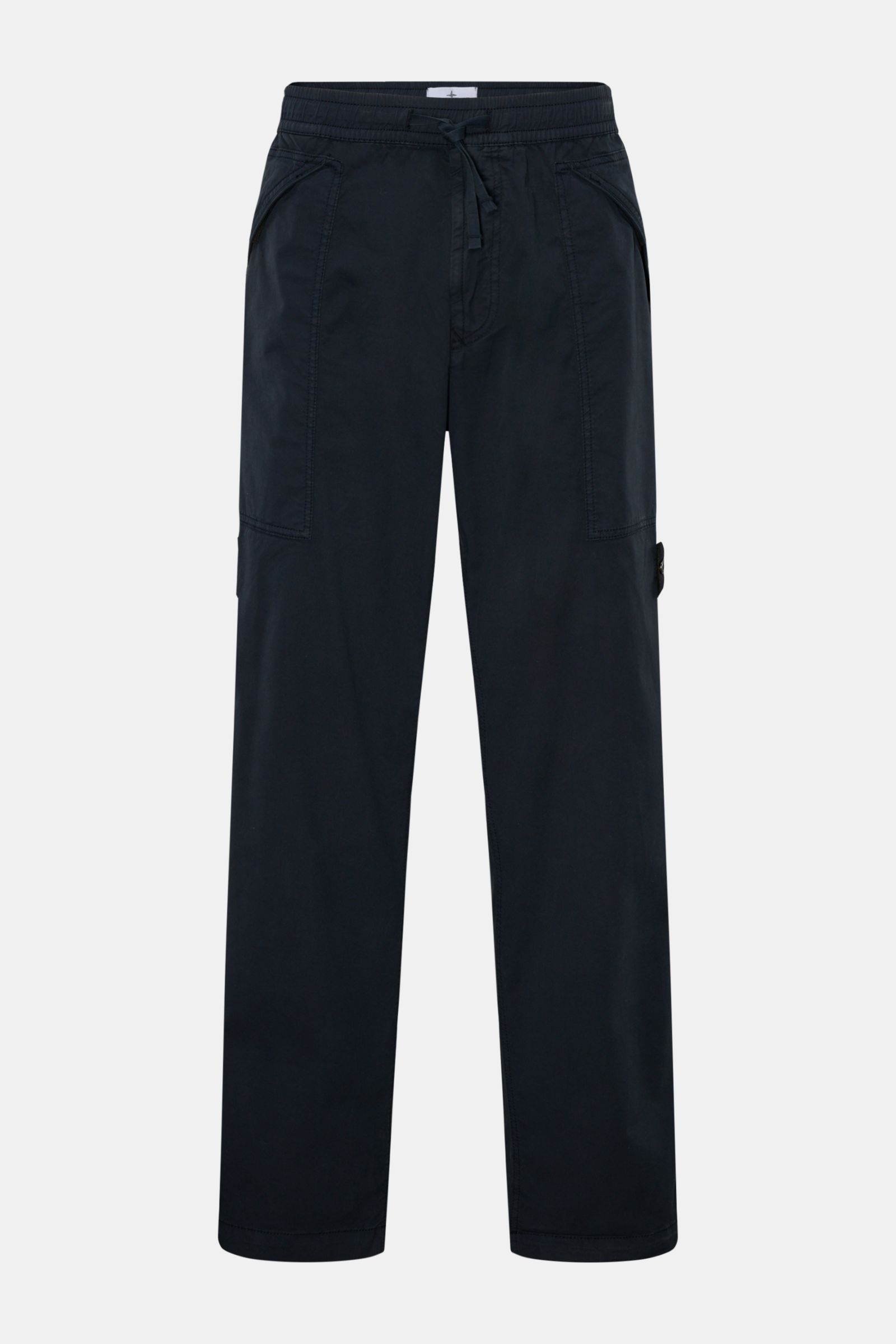 Stone Island Joggpants navy shown from the front, made of lightweight elastic garment-dyed cotton with soft touch, featuring elastic waistband with drawstring, zip fly, zippered hip patch pockets, and signature compass badge for a stylish outdoor look. 