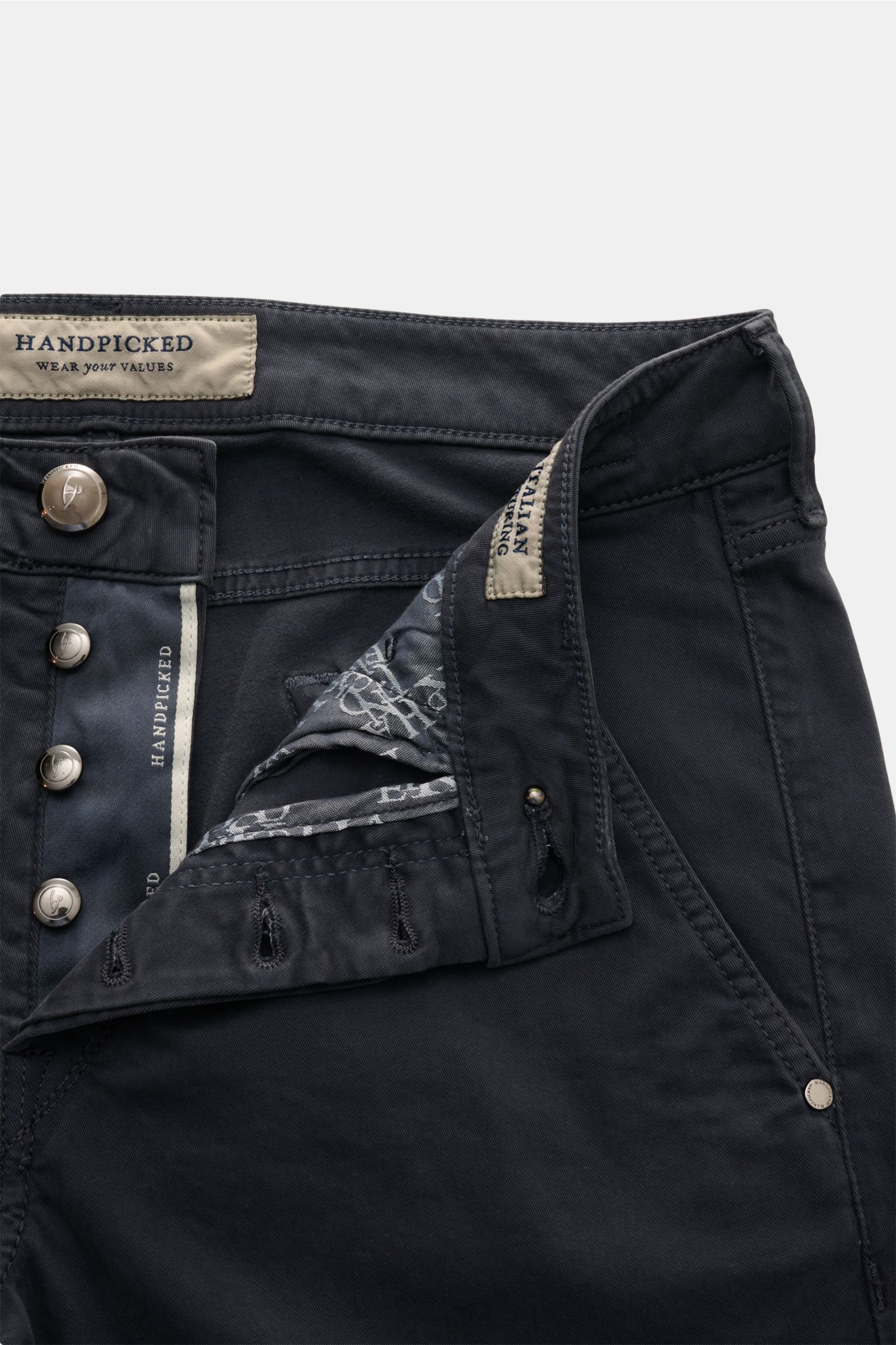 HandPicked Chinos 'Parma' anthracite shown from the front top with button fly open, made of cotton twill, slightly elasticated, soft feel, slim fit, very tapered cut, French pockets, coin pocket with initial, back pockets with stitching, and leather patch