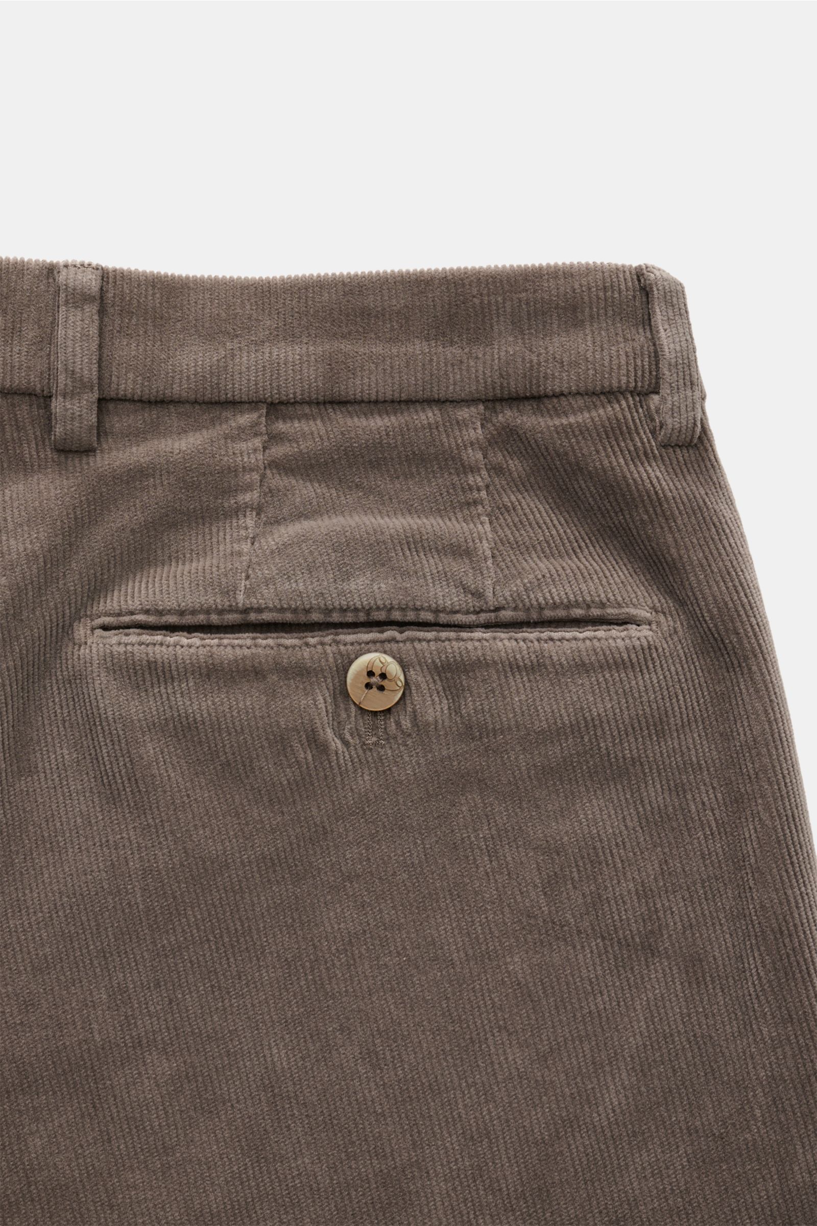 Close-up rear view of GTA Corduroy trousers 'Federico' dark grey, showing fine cotton and modal corduroy fabric with a soft feel, slim fit, slightly tapered cut, waistband with elastic insert, zip and waist button, French pockets, and jetted back pockets 
