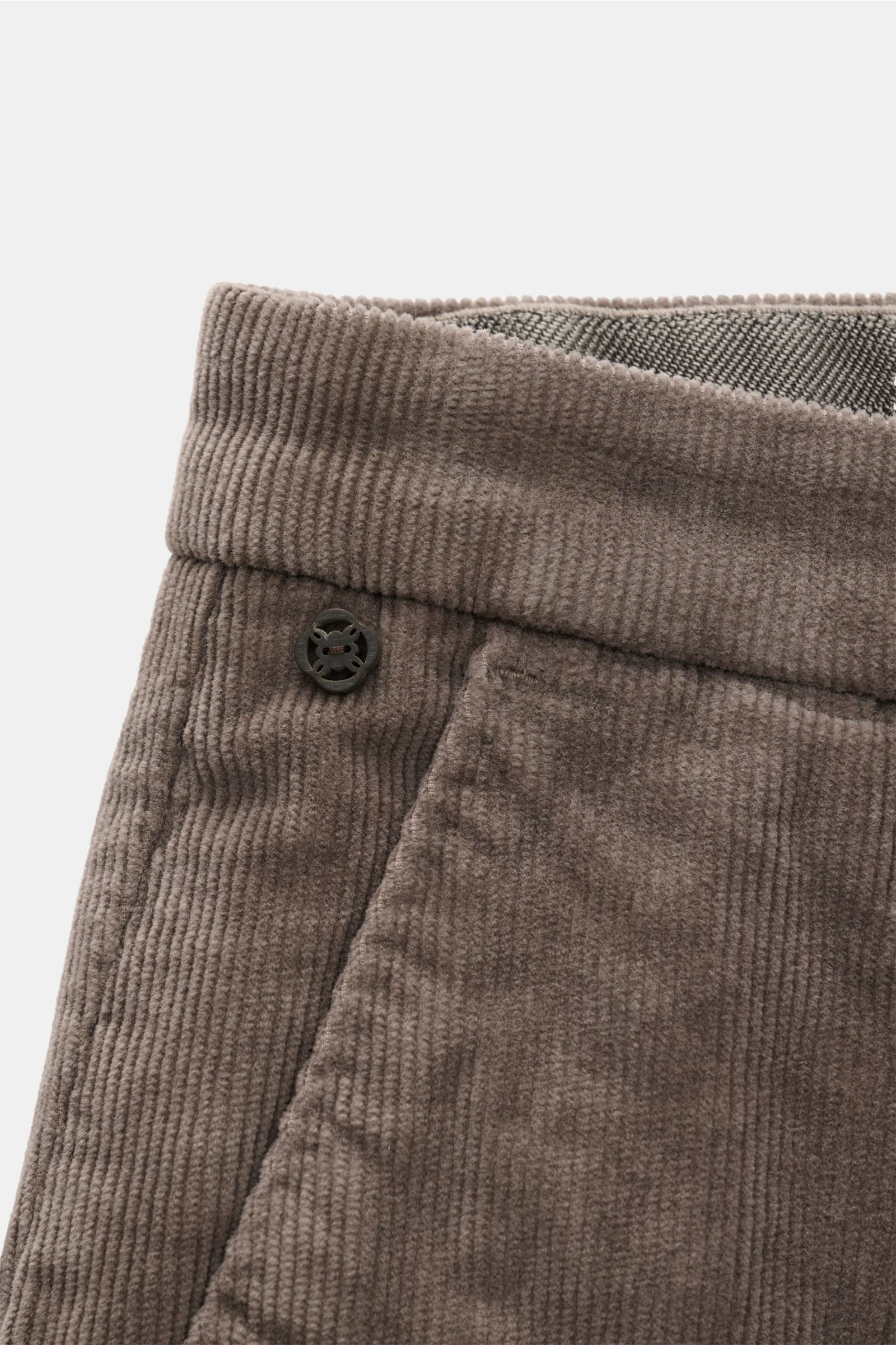 Close-up front-side view of GTA Corduroy trousers 'Federico' dark grey, showing fine cotton-modal corduroy with soft feel, slim fit, slightly elasticated fabric, slightly tapered cut, waistband with elastic insert, zip and waist button, French pockets, an