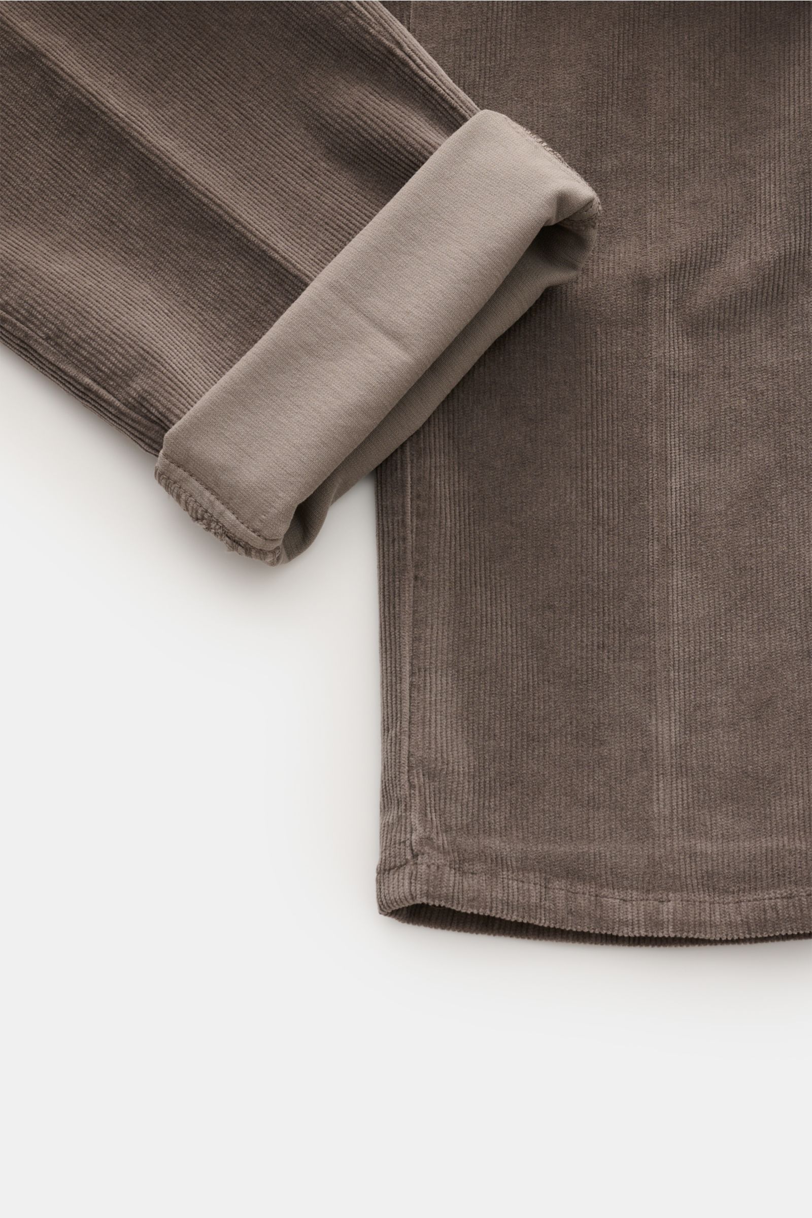 Close-up top-down view of the folded cuff and leg of GTA Corduroy trousers 'Federico' dark grey, made of fine cotton and modal corduroy, slightly elasticated fabric with a soft feel, slim fit, slightly tapered cut, zip and waist button, waistband with ela