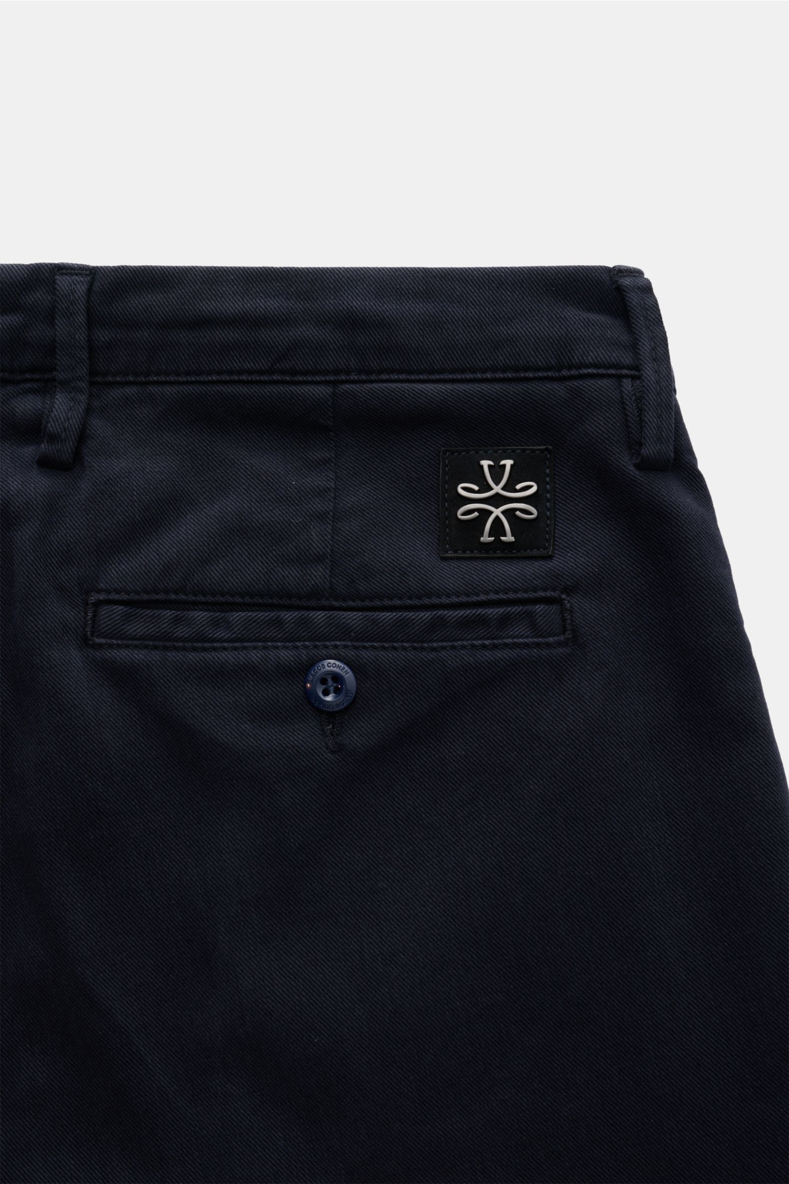 Close-up rear view of Jacob Cohen Chino 'Bobby' navy, showcasing precise Italian craftsmanship in slim fit cotton and Lyocell twill with garment-dyed fabric, elastic quality, soft touch, low rise, zipper and button closure, French pockets, piped coin pock