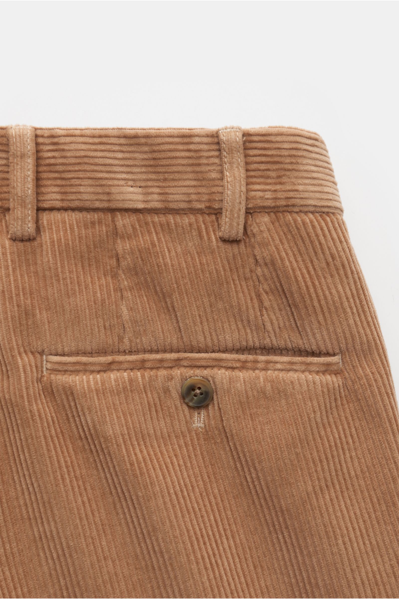 Close-up rear view of Hiltl Corduroy pants 'Parma' beige made of velvety cotton corduroy with a narrow jetted back pocket and button. Modern trousers by HILTL: The model 'Parma' is made of velvety cotton corduroy in a casual fit – perfect for styling with