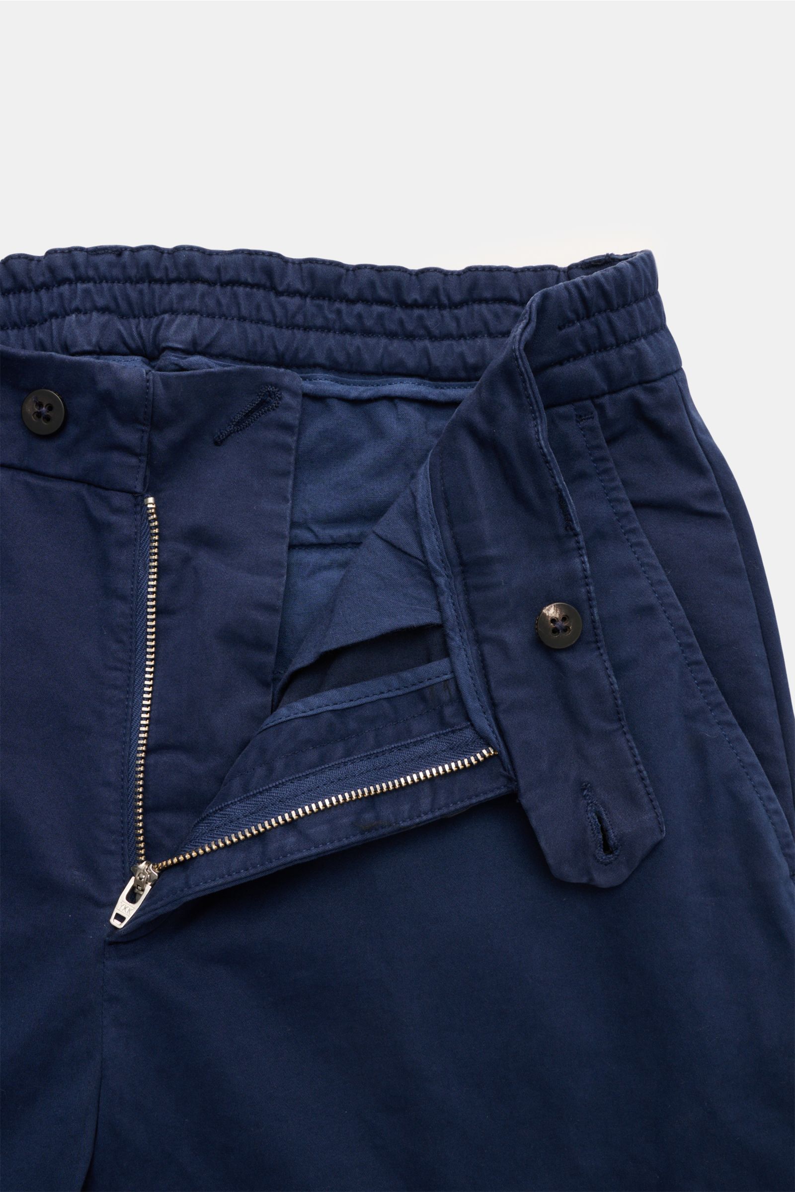 Close-up front view of 04651/ A trip in a bag Cotton trousers 'Flex' navy with zipper open, button, and elasticated waistband. Modern fit for everyday looks: The comfortable cotton trousers 'Flex' by 04651/ A TRIP IN A BAG with comfort stretch content are