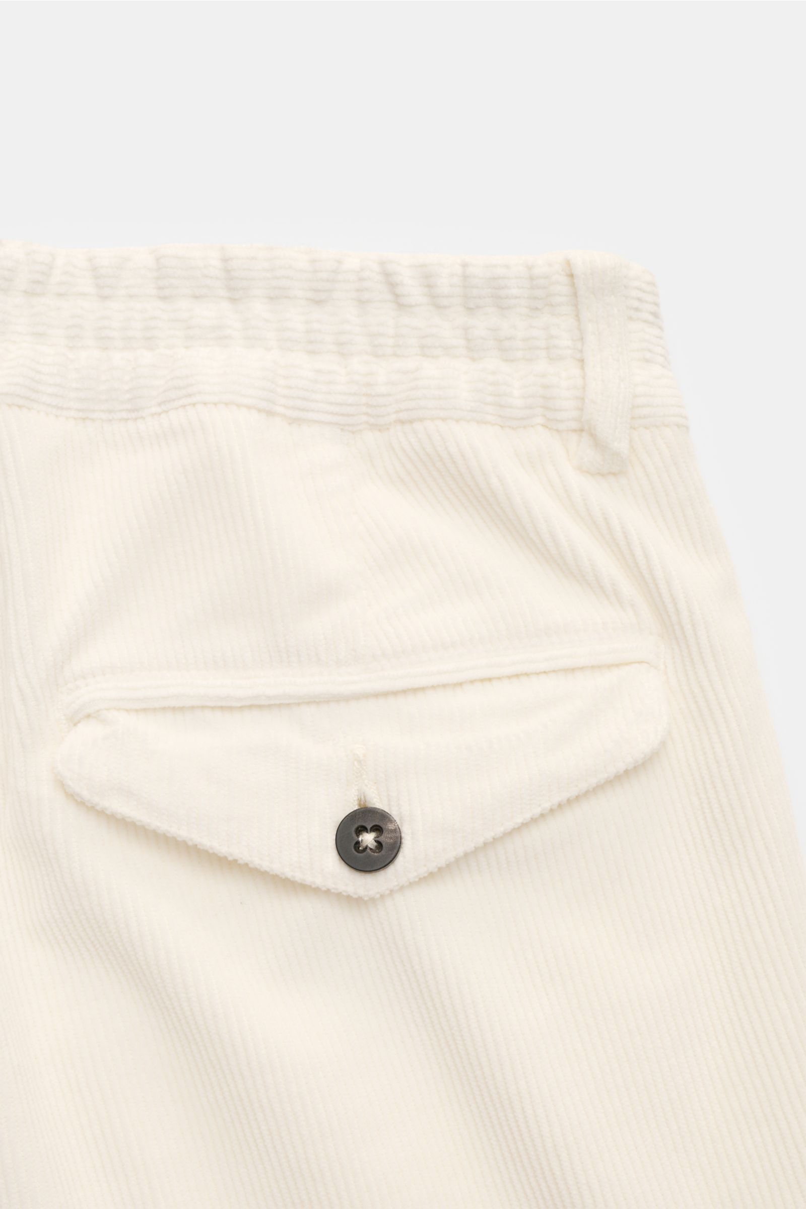 Close-up rear view of 04651/ A trip in a bag Corduroy trousers cream showing the back pocket with button flap and partially elasticated waistband.

Welcome to the Autumn Winter Collection by 04651/ A TRIP IN A BAG – inspired by Finland’s contrasts betw