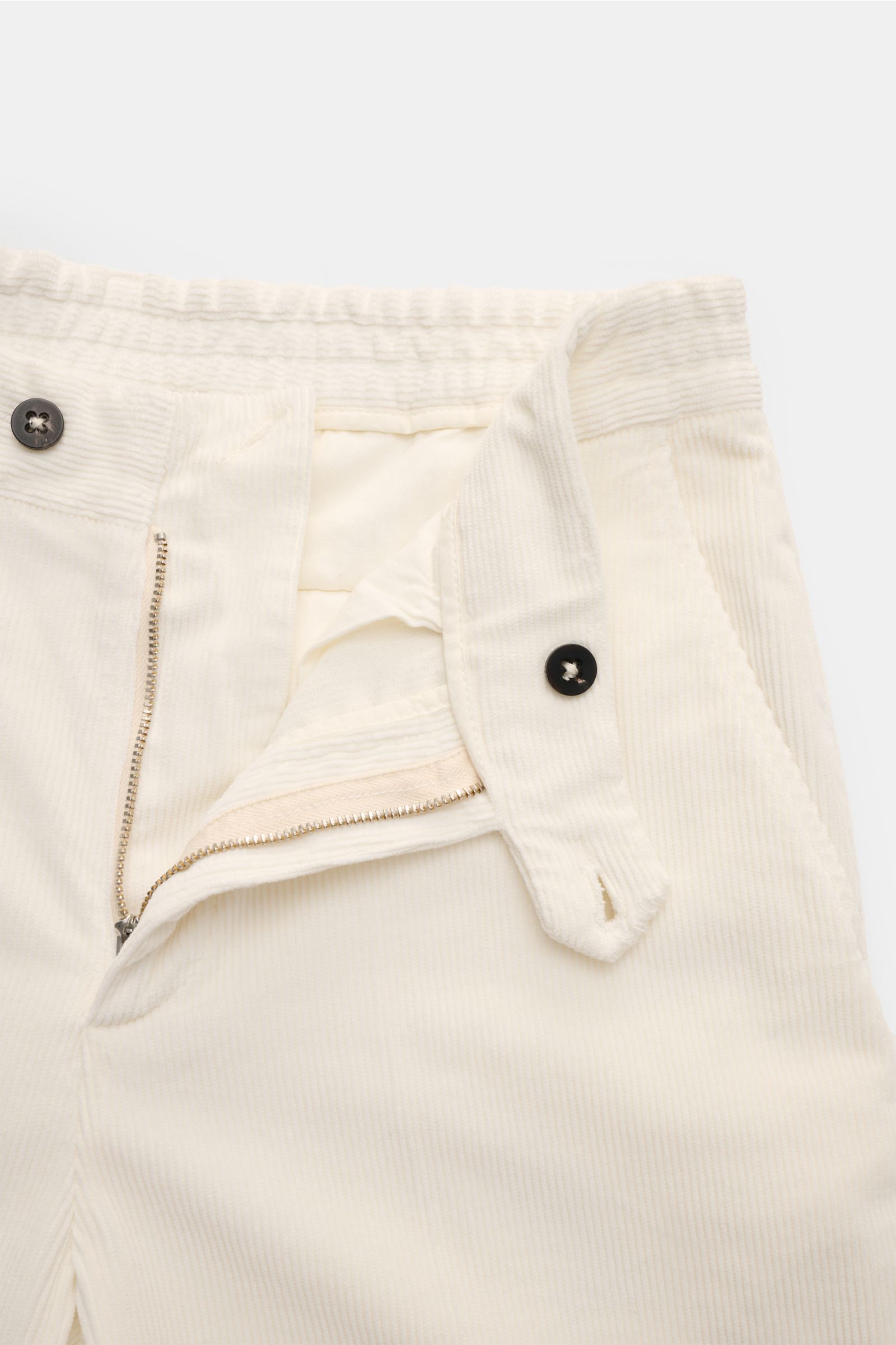 Close-up front view of 04651/ A trip in a bag Corduroy trousers cream showing zip, partially elasticated waistband, and black buttons

Welcome to the Autumn Winter Collection by 04651/ A TRIP IN A BAG – inspired by Finland’s contrasts between city and 