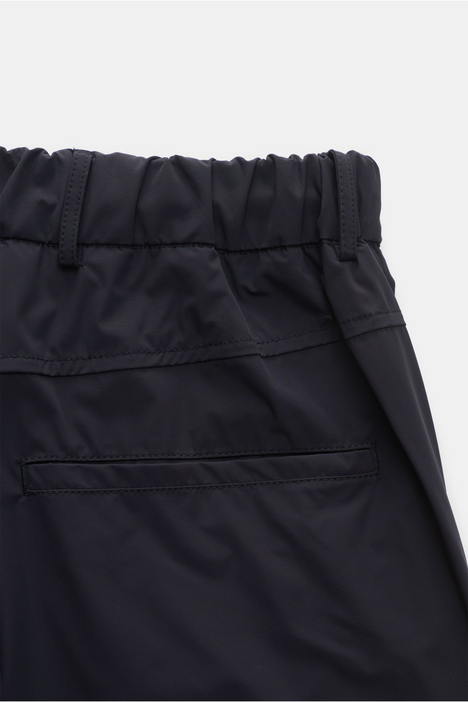 The Product is the Hero Jogpants 'Travel Pant' navy, Detailaufnahme von hinten, Slim Fit, kurze, schmal zulaufende Microfaserhose mit elastischem Bund, Leistentasche, wasserabweisend und atmungsaktiv.