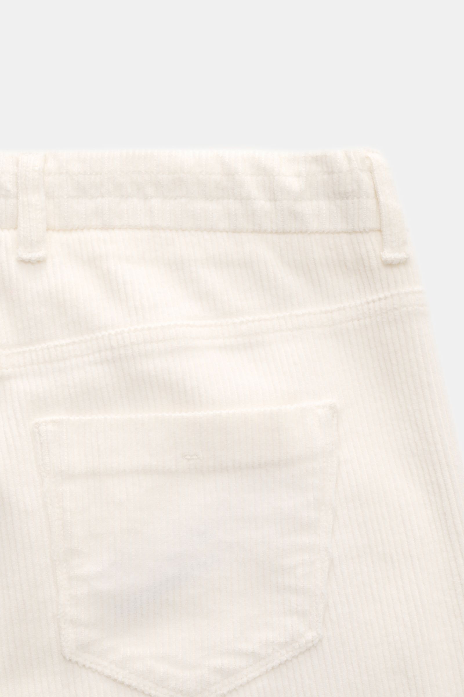 Close-up rear view of Ace Denim Corduroy jogger pants off-white showing soft pure cotton fabric, slim fit, tapered cut, elasticated waistband with drawstring, zip and waist button, single pleat, and French pockets, combining casual retro charm with a feel