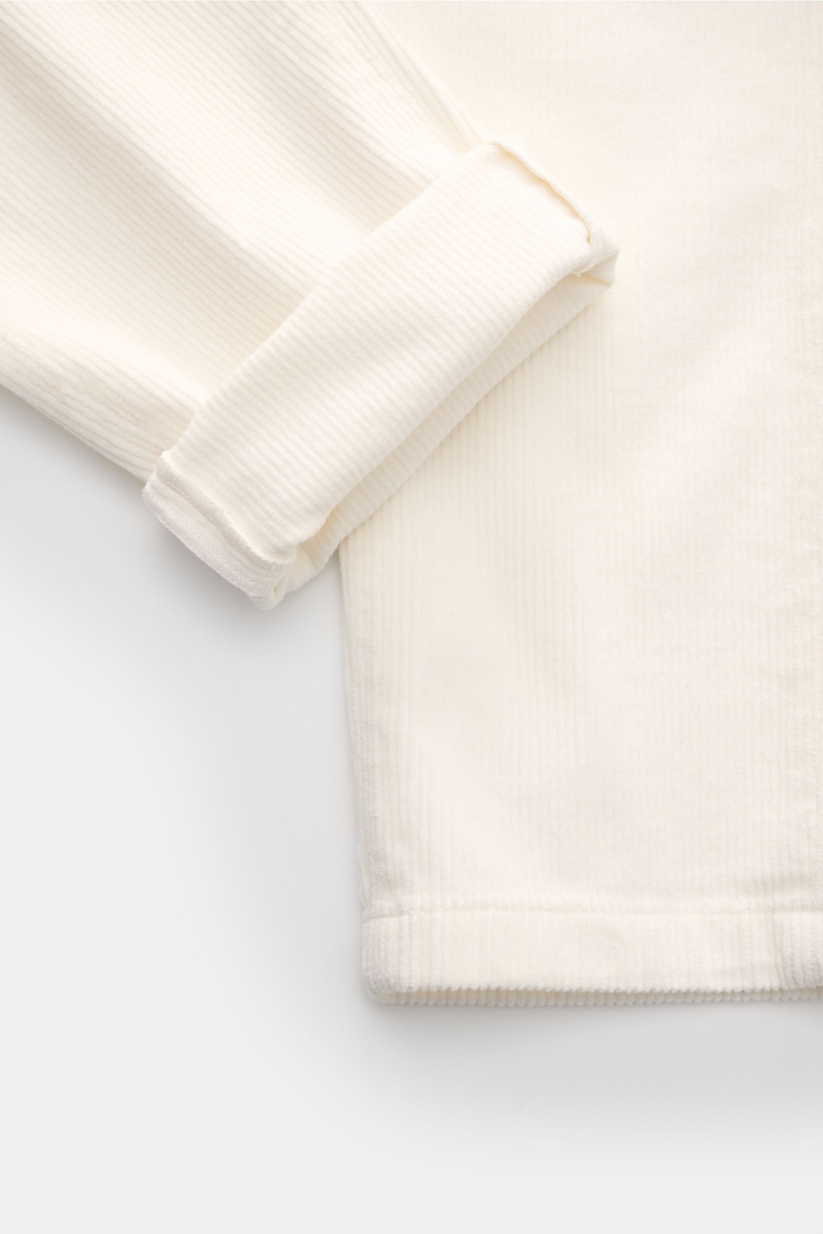 Close-up front view of Ace Denim Corduroy jogger pants off-white, showing soft pure cotton fabric with slim fit, tapered cut, elasticated waistband, zip, button, single pleat, and French pockets.