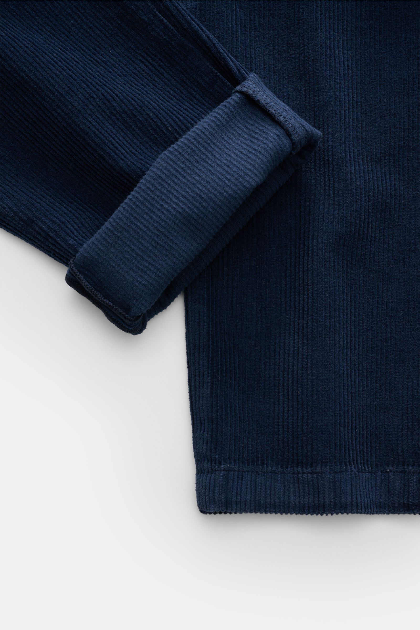 Close-up front view of the navy Ace Denim Corduroy jogger pants navy showing soft pure cotton fabric with slim fit, tapered cut, and folded cuff.