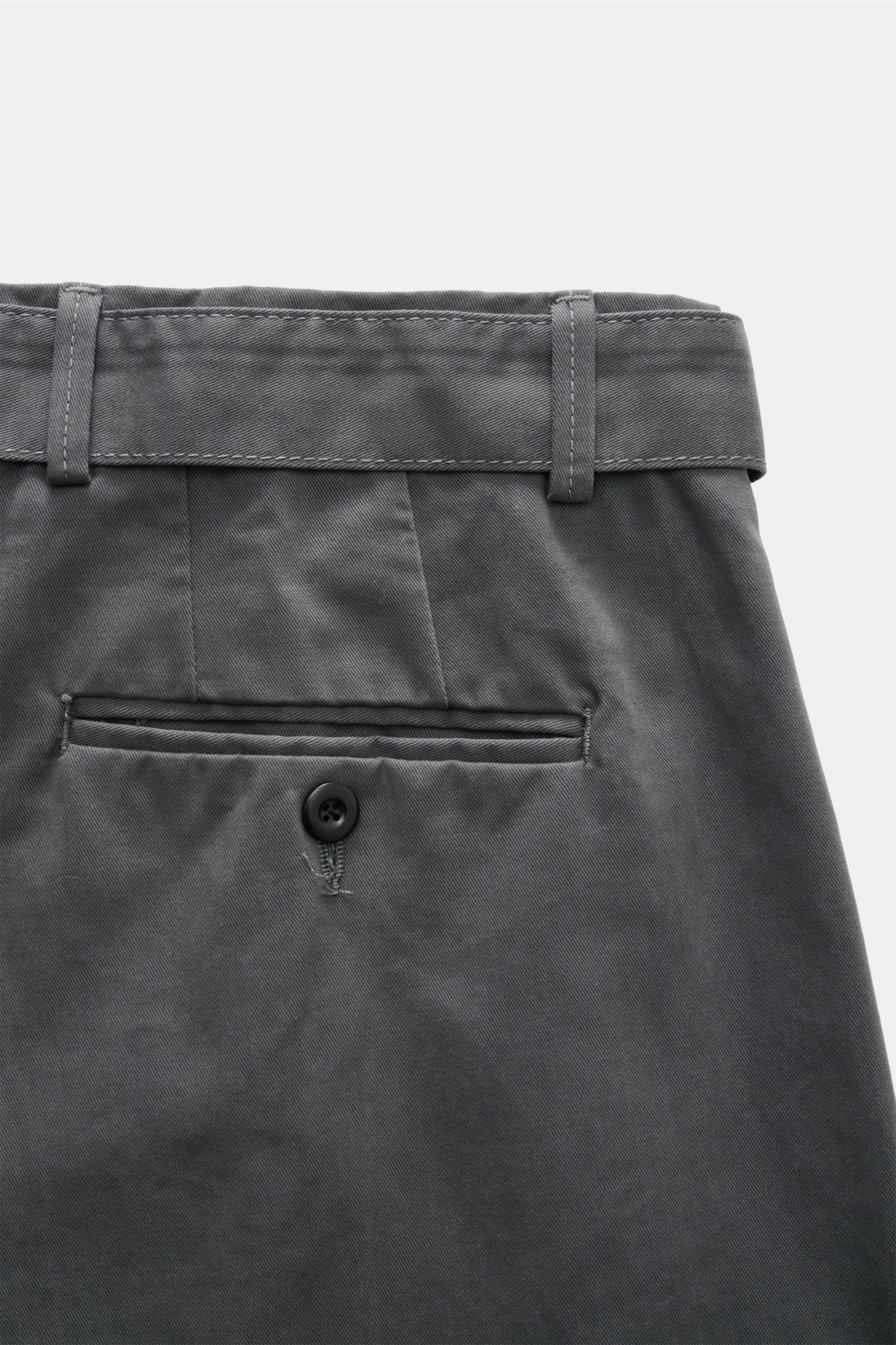 Close-up rear view of Officine Générale Chinos dark grey showing waistband with belt loops, button fly, double pleat, and back pockets with button.

Parisian nonchalance at its most stylish: 