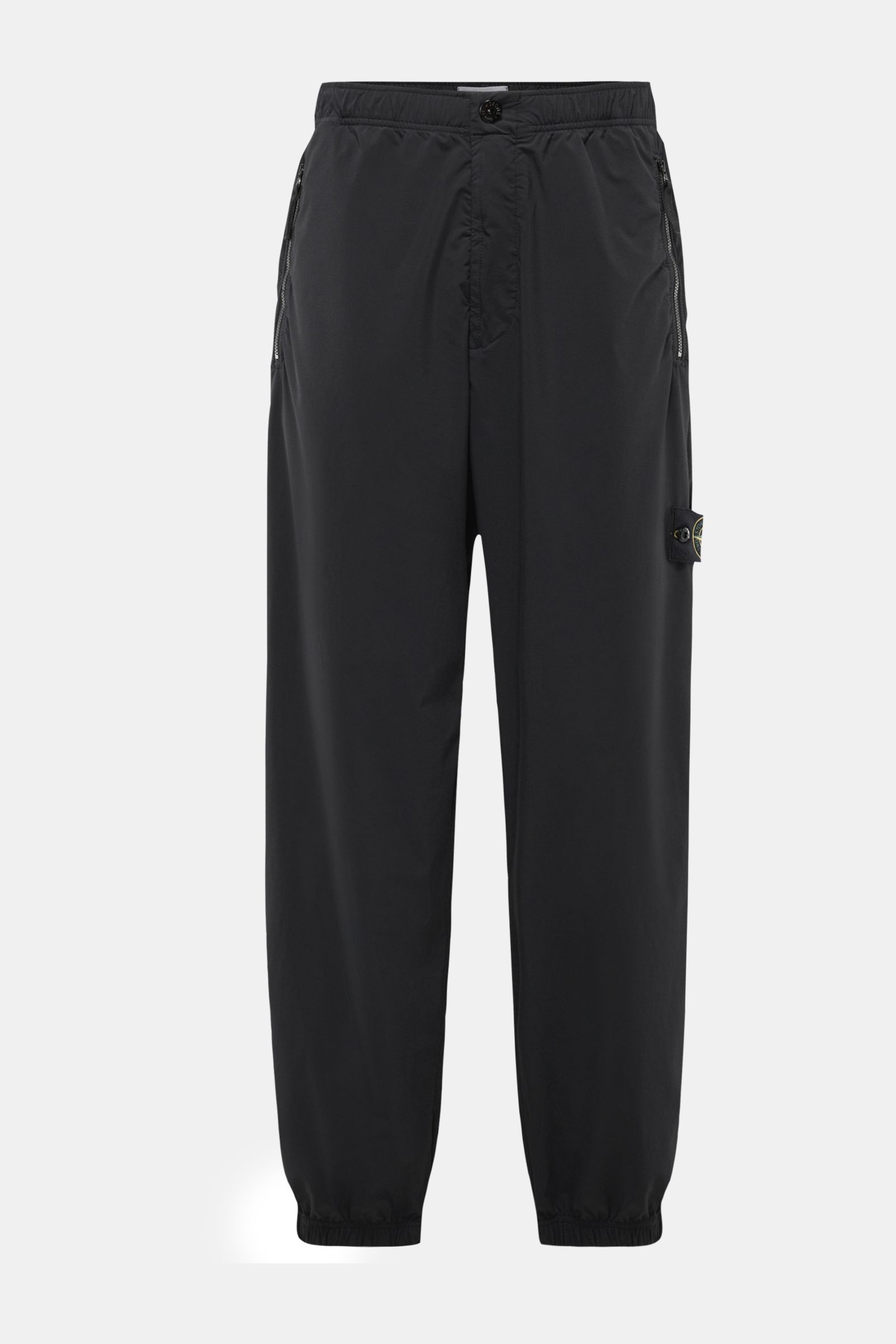 Stone Island Jogger pants black shown from the front, made of high-quality microfibre with a regular fit, tapered cut, zip pockets, elasticated cuffs, and a partially elasticated waistband with internal drawstring; designed for sporty, relaxed spring casu
