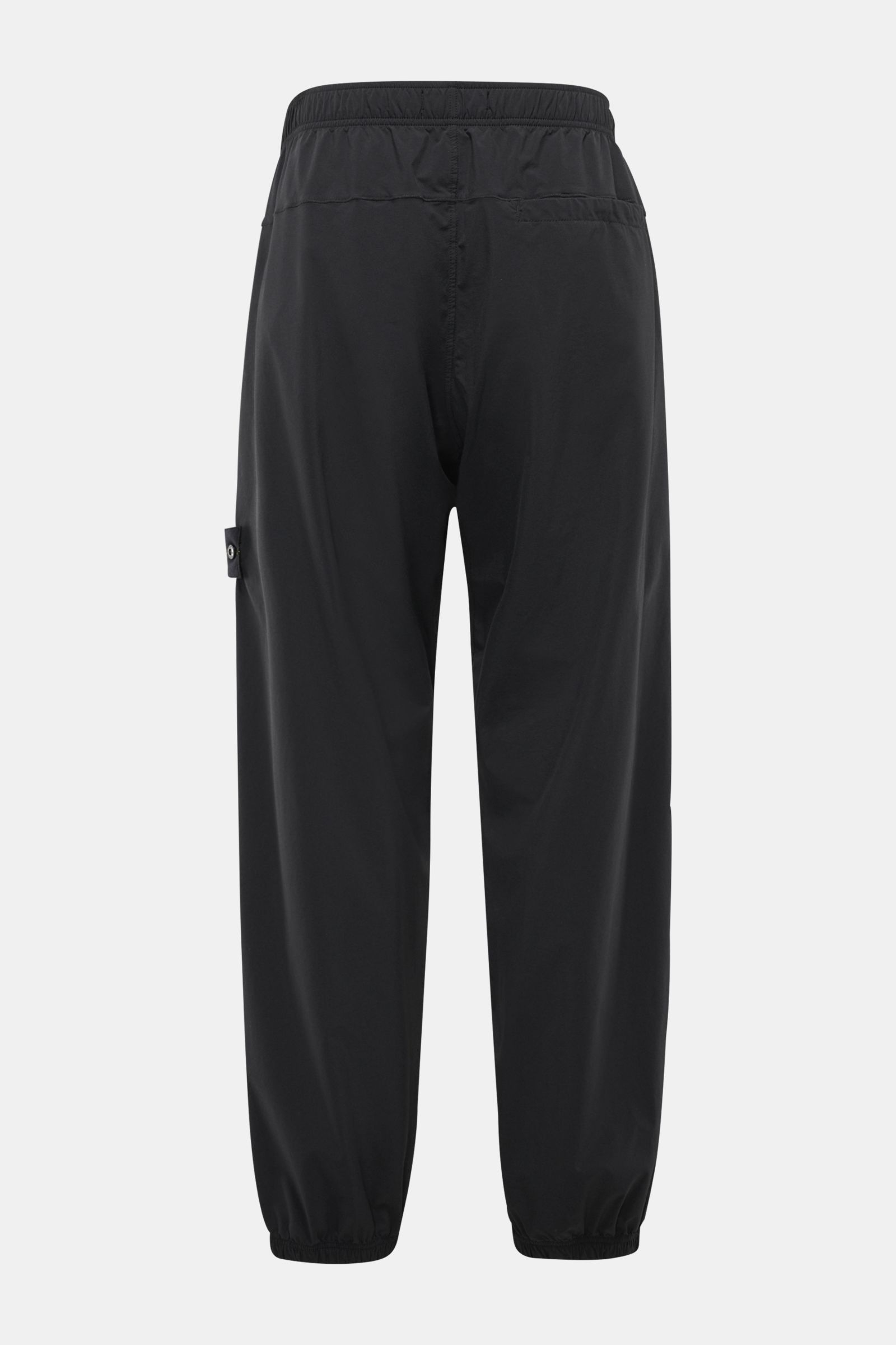 Rear view of Stone Island Jogger pants black in high-quality microfibre with a slightly robust touch, regular fit, elasticated waistband, zip pockets, and elasticated cuffs, designed for sporty and relaxed casual spring looks.