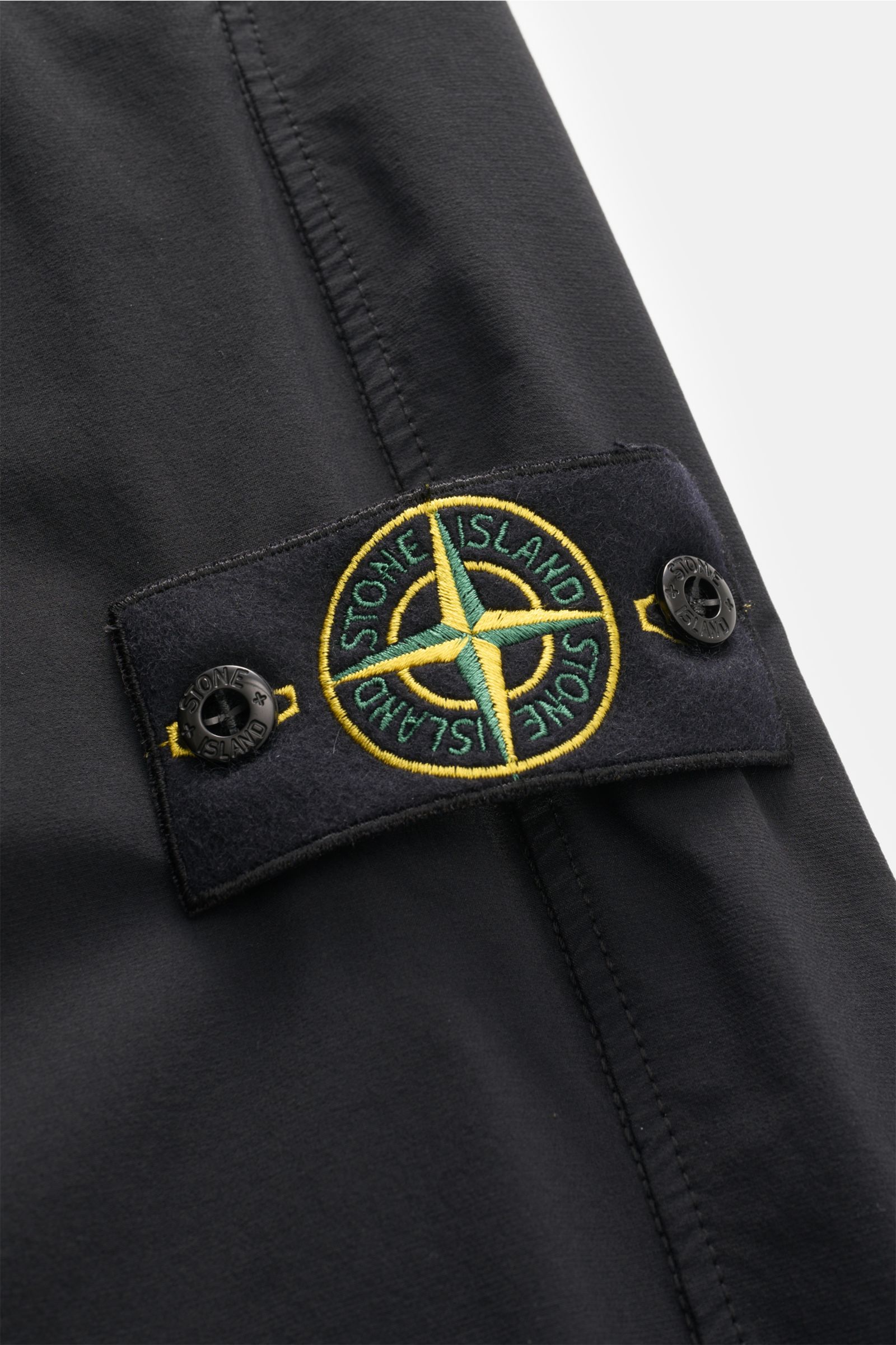 Close-up view of the Stone Island Jogger pants black showing the stitched logo patch with buttons on high-quality microfibre fabric.

Create casual looks for the spring season: These jogger pants by STONE ISLAND are synonymous with sporty and relaxed c