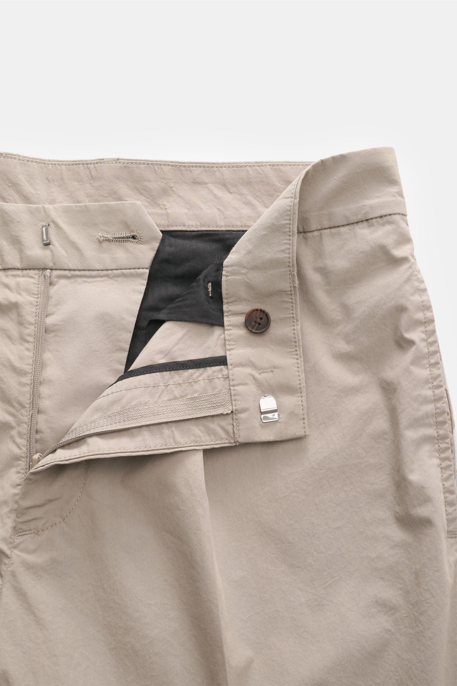 Close-up front view of Emporio Armani Cotton trousers taupe showcasing the zip and hook fastener, button, and smooth pure cotton fabric. Summer essential: These light cotton trousers by EMPORIO ARMANI are luxuriously lightweight and create stylish looks e