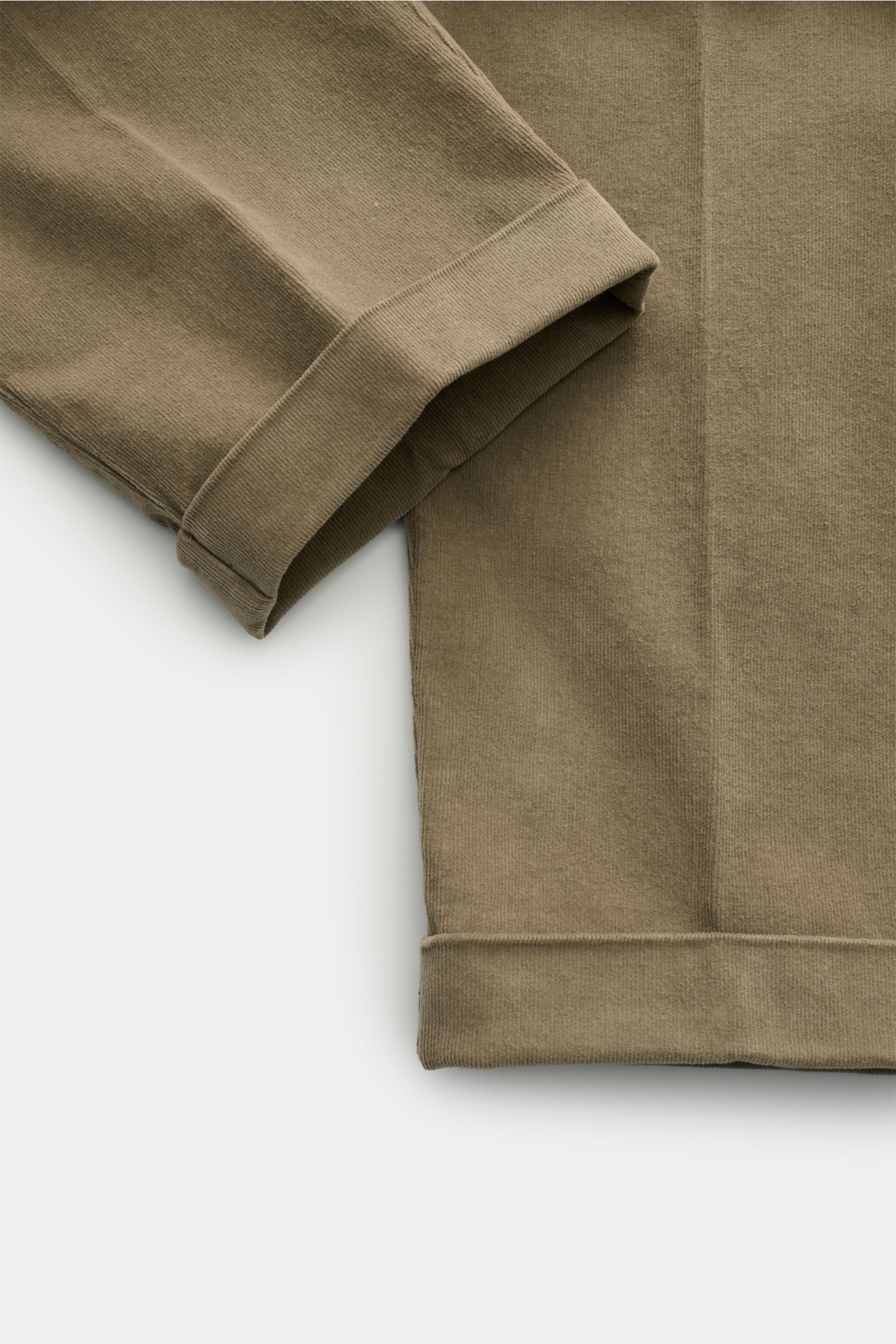 Close-up view of 04651/ A trip in a bag Corduroy trousers taupe showing the ankle-length tapered fit with fixed hem turn-up in soft cotton corduroy fabric. Retroesque inspiration from 04651/ A TRIP IN A BAG: These trousers in slightly stretchy cotton cord