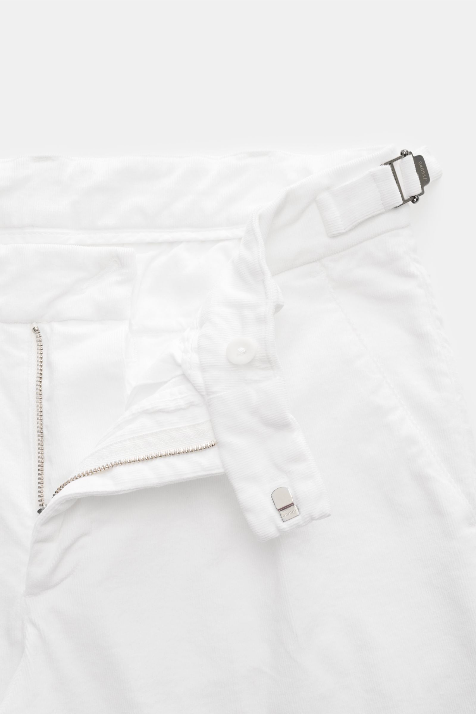 Close-up front view of 04651/ A trip in a bag Corduroy trousers off-white, showing zip, hook fastener, side adjusters, double pleat in soft cotton corduroy with stretch. Retroesque inspiration from 04651/ A TRIP IN A BAG: These trousers in slightly stretc