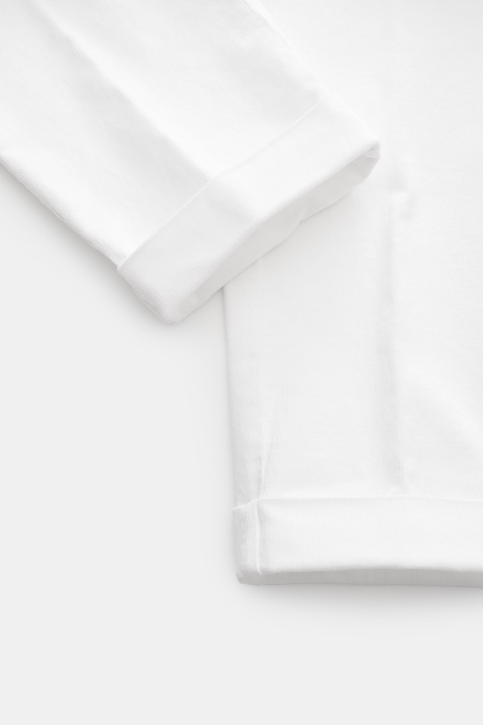 Close-up front view of 04651/ A trip in a bag Corduroy trousers off-white showing ankle-length tapered fit with fixed hem turn-up in soft stretchy cotton corduroy. Retroesque inspiration from 04651/ A TRIP IN A BAG: These trousers in slightly stretchy cot