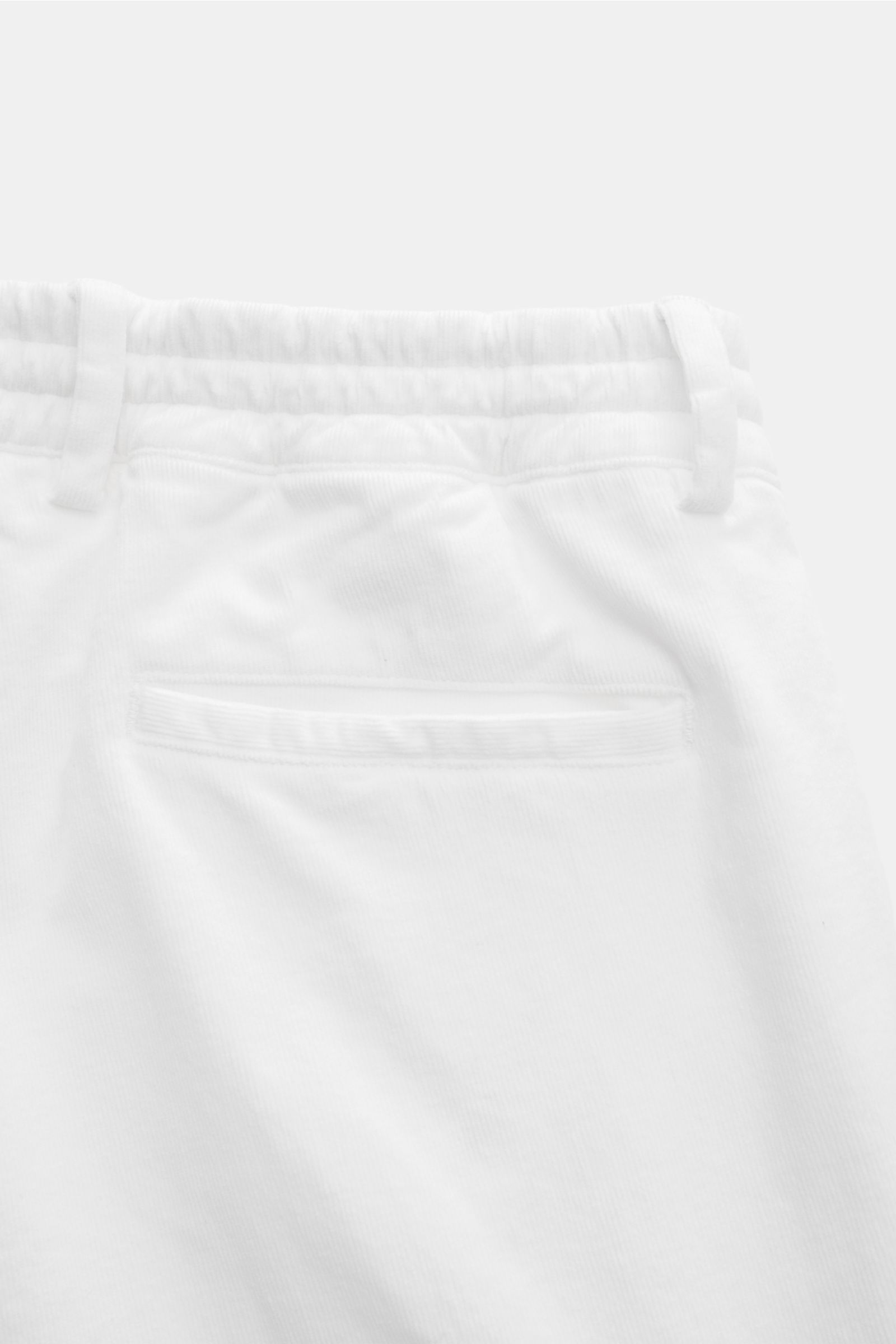 Close-up rear view of 04651/ A trip in a bag Cordhose offwhite cotton cord pants with elastic waistband, pocket, and soft texture.