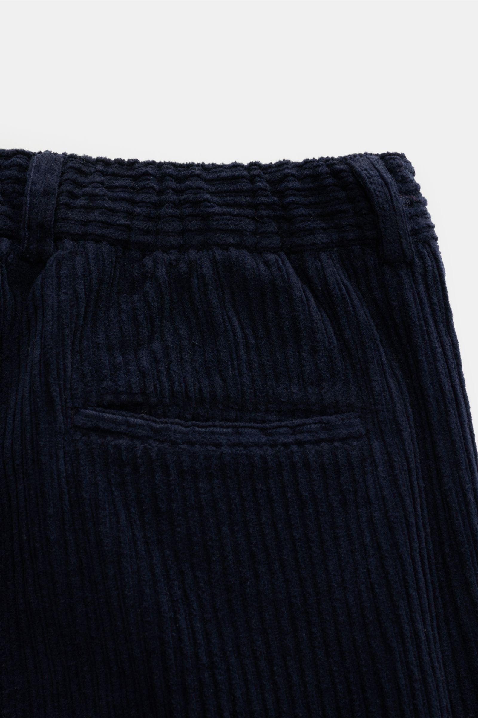 Close-up rear view of 04651/ A trip in a bag Corduroy cargo pants navy, showing wide wale cotton corduroy, soft feel, tapered fit, regular thigh width, ankle length, slightly tapered cut, zip and waist button, partially elasticated waistband with drawstri