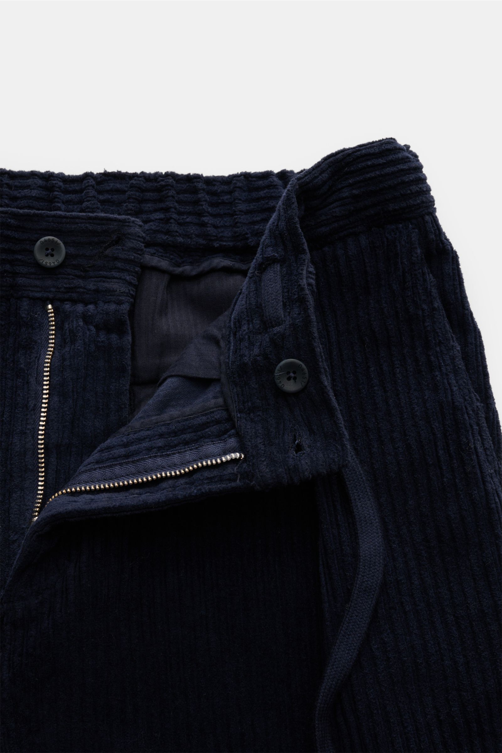 Close-up front view of 04651/ A trip in a bag Corduroy cargo pants navy, wide wale cotton corduroy with slight stretch, soft feel, tapered fit, regular thigh width, ankle length, zip and waist button, partially elasticated waistband with drawstring, Frenc