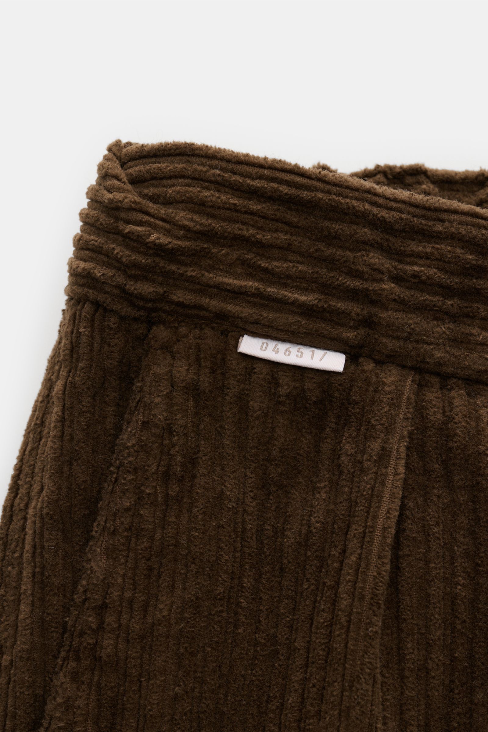Close-up front view of 04651/ A trip in a bag Corduroy cargo pants brown, showing wide wale cotton corduroy with slight stretch, soft feel, tapered fit, regular thigh width, ankle length, zip and waist button, partially elasticated waistband with drawstri