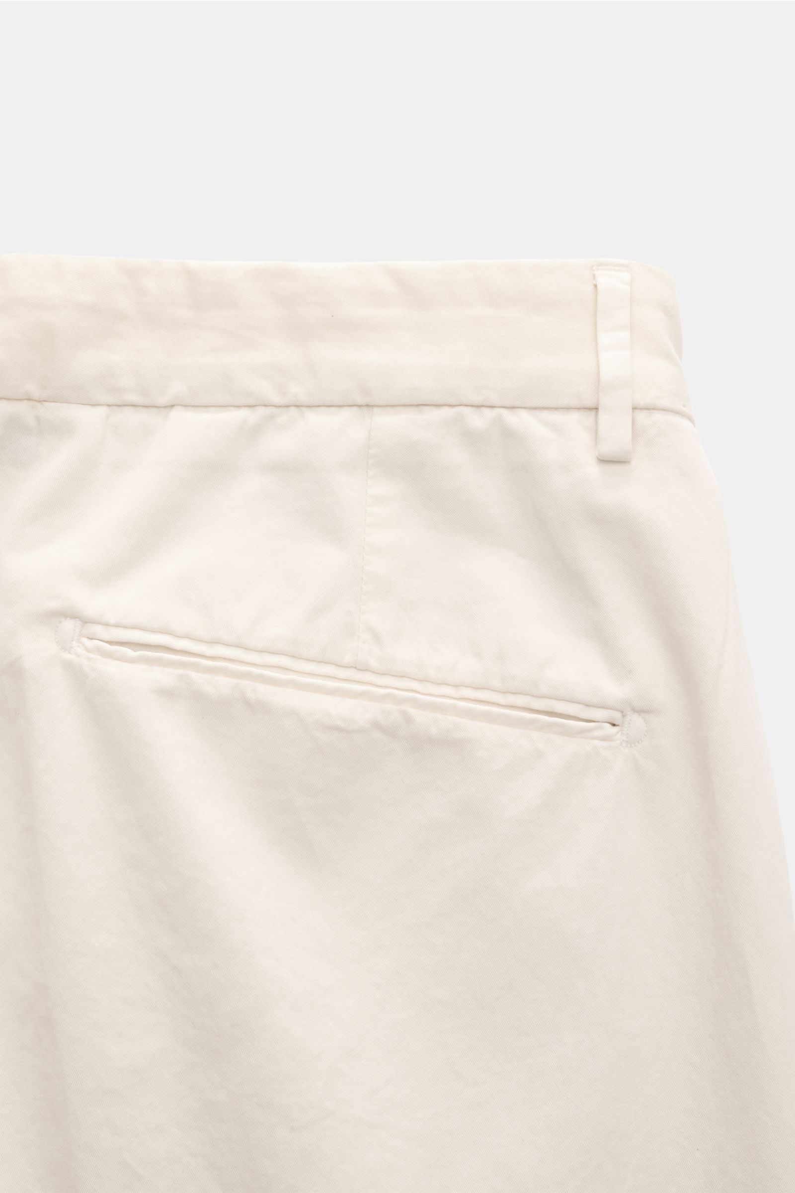 Close-up rear view of Santaniello Chinos 'Arsenio' cream in soft, fine cotton twill with jetted back pocket and fixed hem turn-up.

Casual meets stylish: The chinos 'Arsenio' by SANTANIELLO are made of soft twill in pure cotton with a single pleat – fo