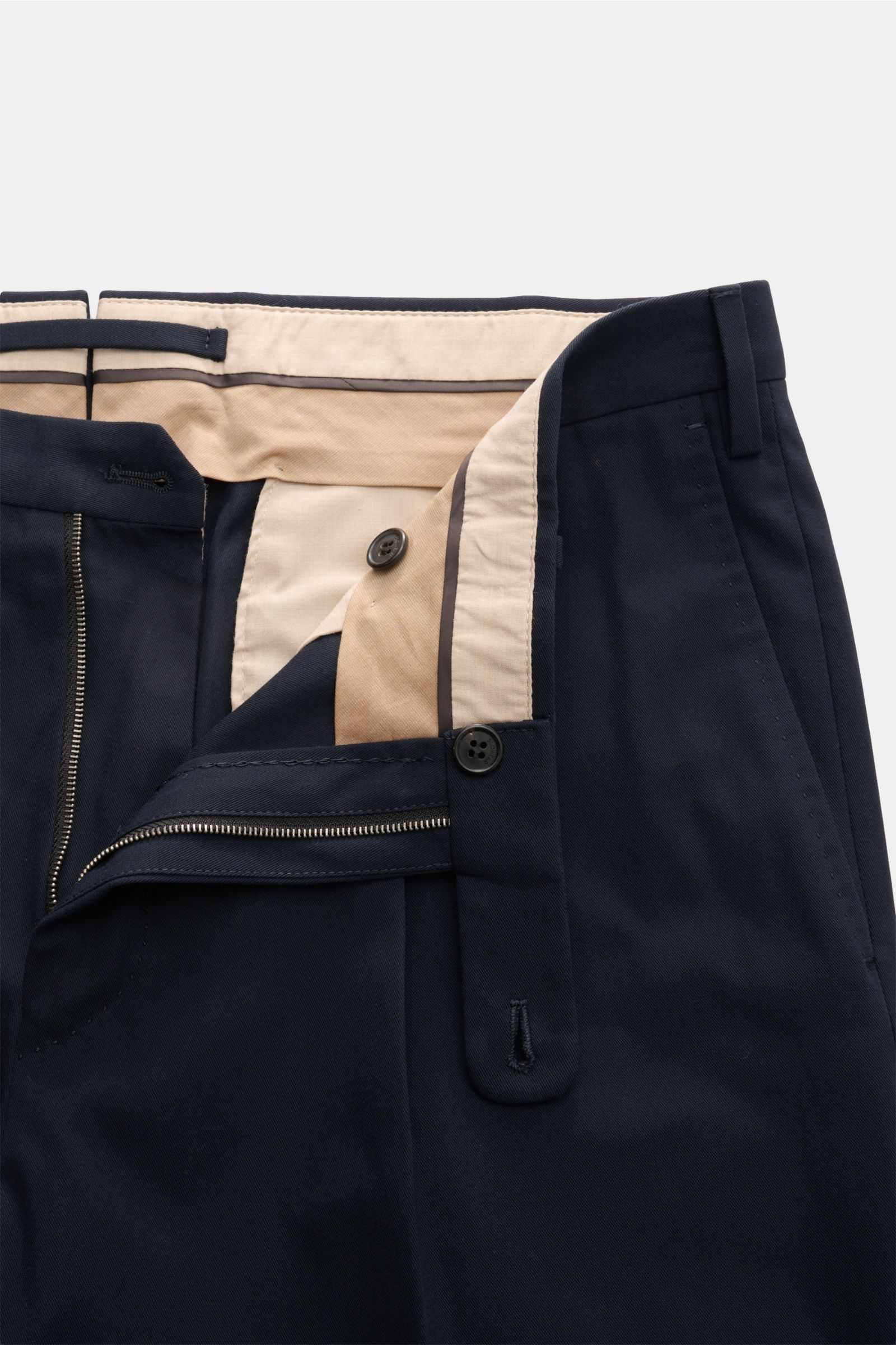 Close-up front view of Incotex Cotton trousers navy, showing zip, waist button, extended buttoned tab, and beige inner lining.