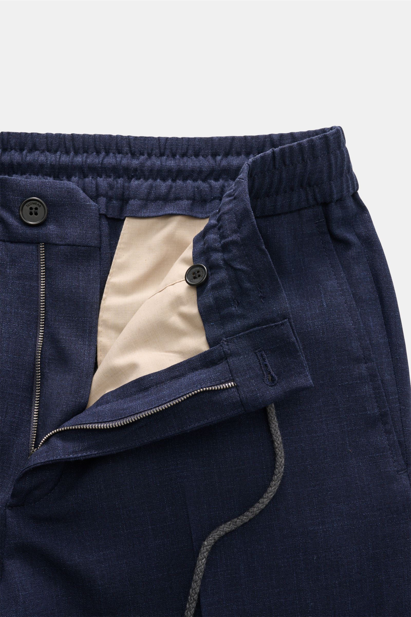 Close-up front view of Incotex Jogger pants dark blue mottled showing elasticated waistband with drawstring, zip, button, and beige inner lining.