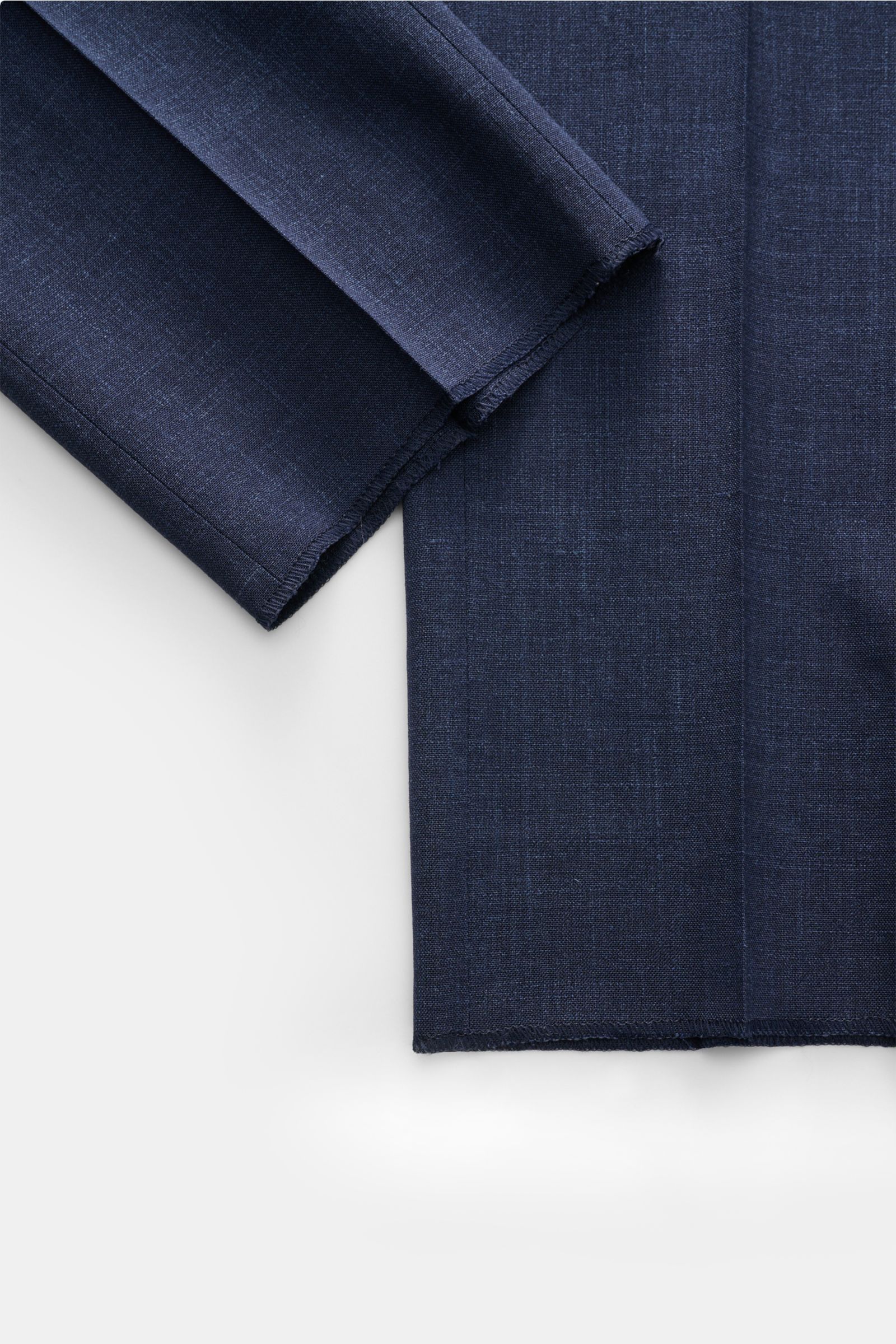 Close-up front view of Incotex Jogger pants dark blue mottled fabric showing fine wool, silk, and linen blend with smooth feel, regular fit, slightly tapered cut, elasticated waistband with drawstring, French pockets, back pockets with button, zip and wai