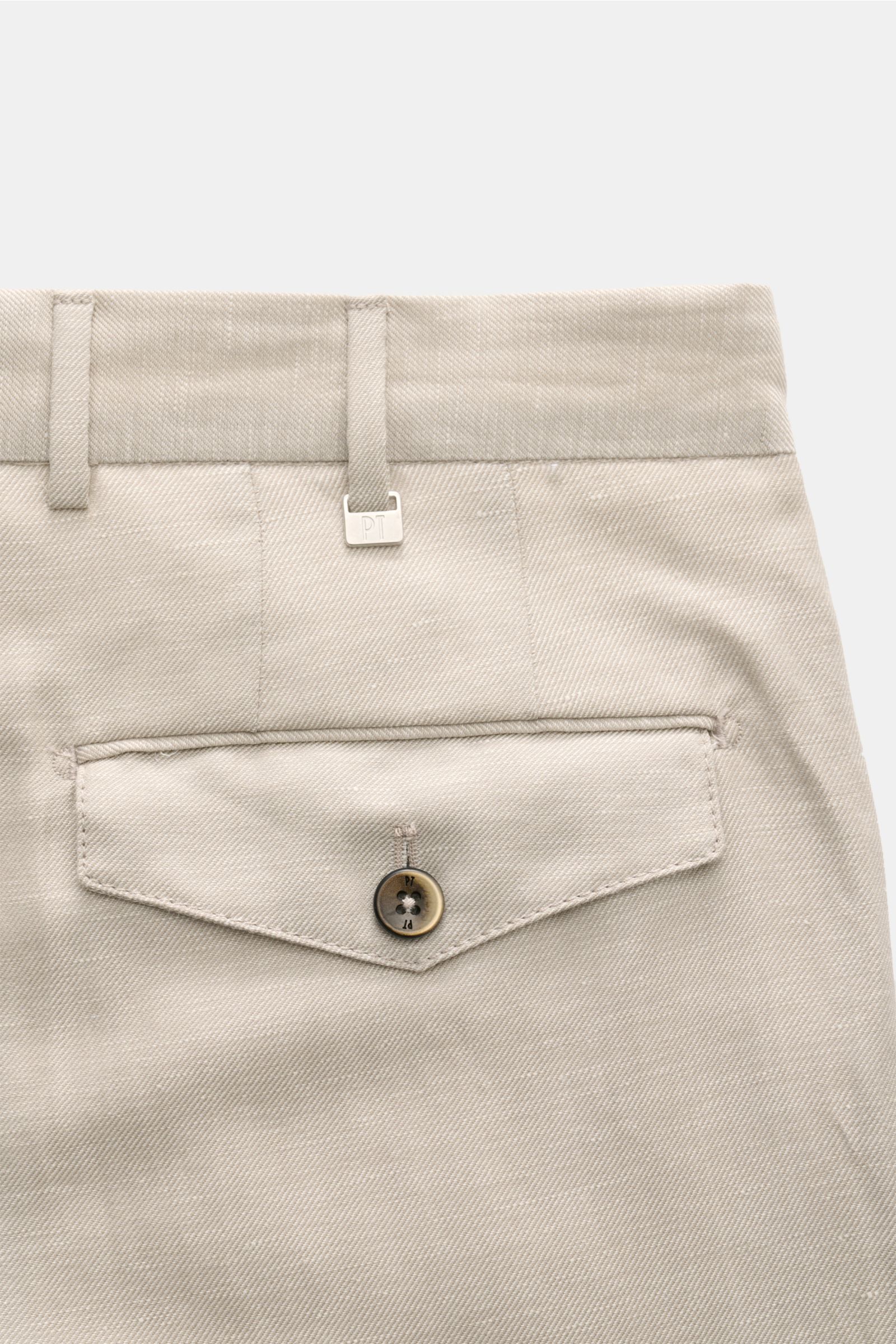 Close-up rear view of PT Torino Trousers 'Carrot Fit' sand, showing high waist, belt loops, buttoned flap pocket, and distinctive twill texture. 

Italian nonchalance meets the lightness of linen and virgin wool: With the short tapered cut of the model