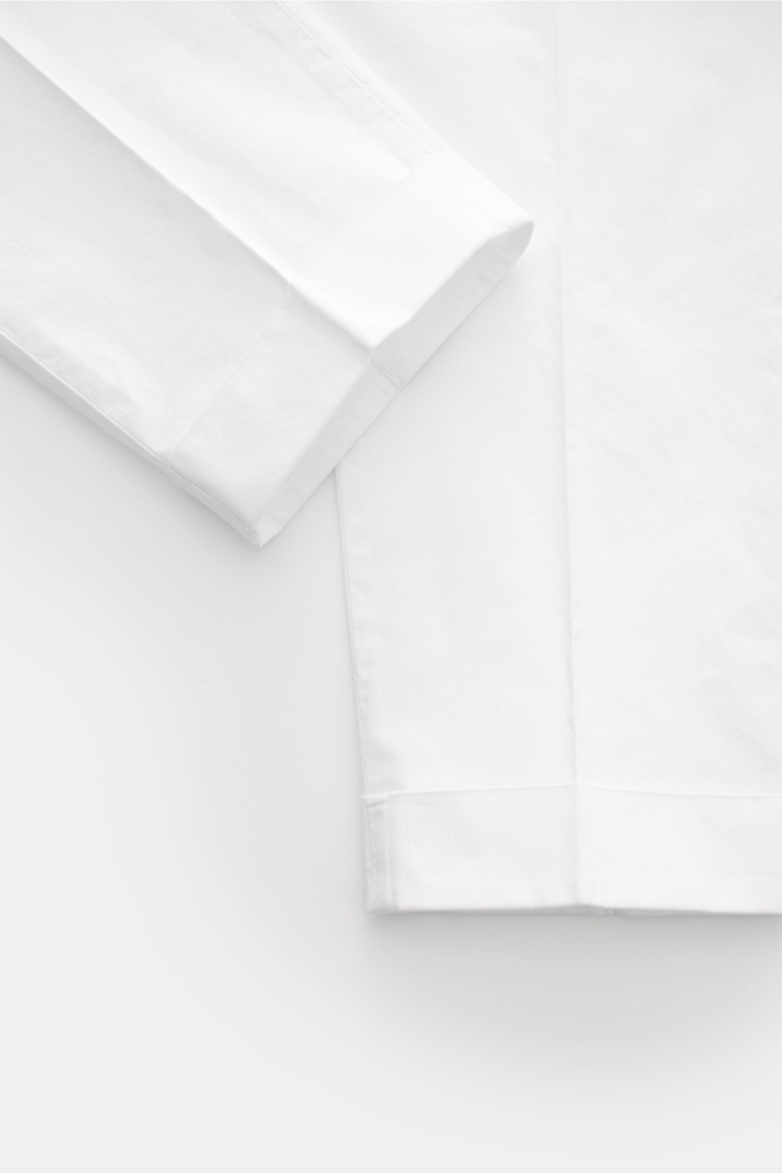 White cotton PT Torino Chinos 'Rebel Fit' shown from a close-up side angle, highlighting the fixed hem turn-up and tapered fit. 

You can’t go wrong with PT TORINO: These comfortably cut chinos made of cotton in a trendy tapered fit are a stylish compa