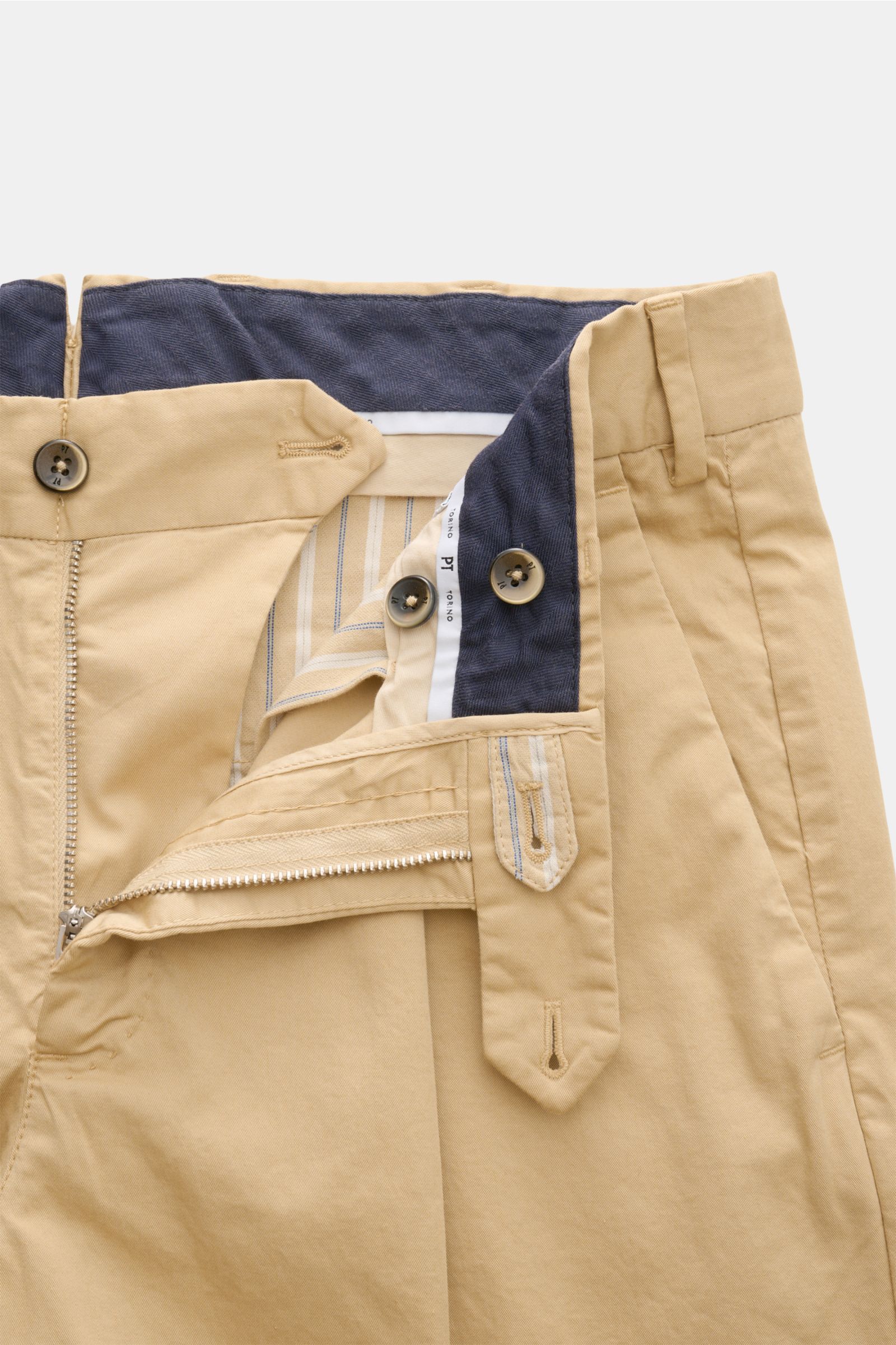 PT Torino Chinos 'Union Fit' beige shown from front close-up with open zip and waist buttons, cotton twill fabric, slight stretch, soft feel, regular fit, tapered cut, single pleat, French pockets, small watch pocket, jetted back pockets with button. 


