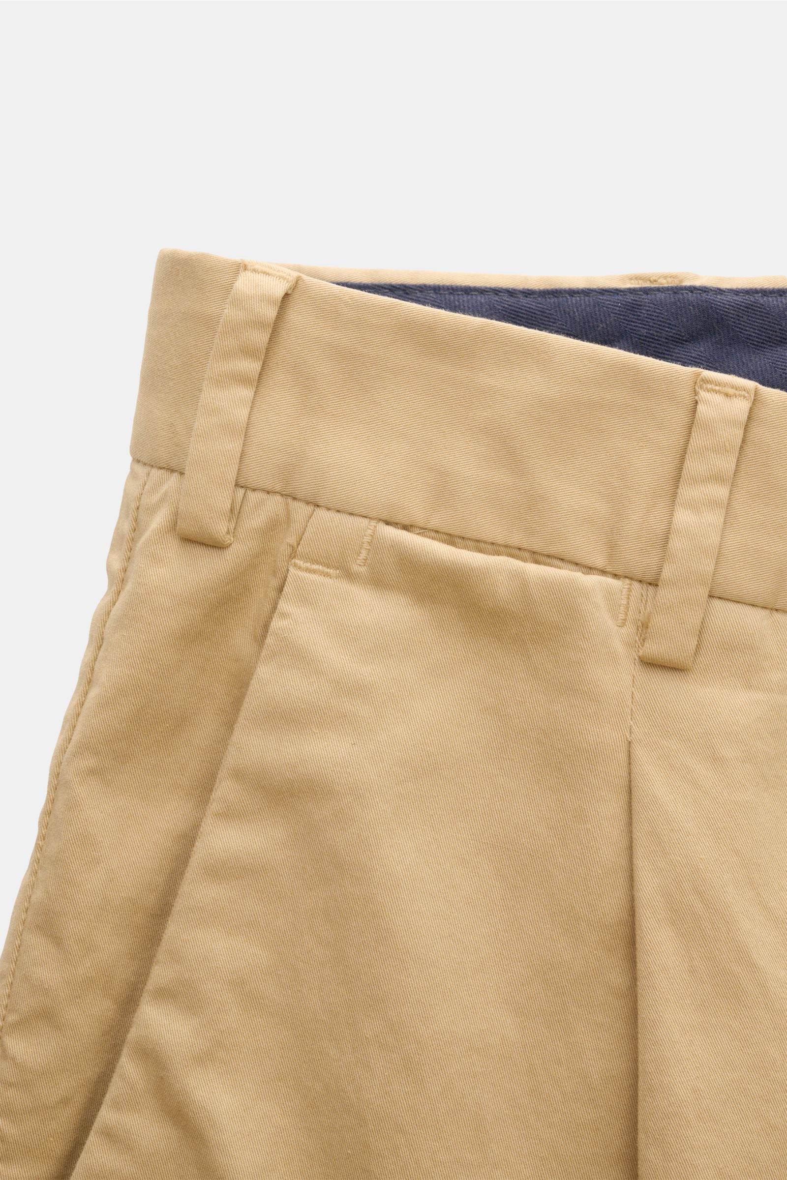 Close-up front view of PT Torino Chinos 'Union Fit' beige, made from classic cotton twill with a soft feel, slight stretch, regular fit, tapered cut, zip and waist buttons, single pleat, French pockets, small watch pocket, and jetted back pockets with but