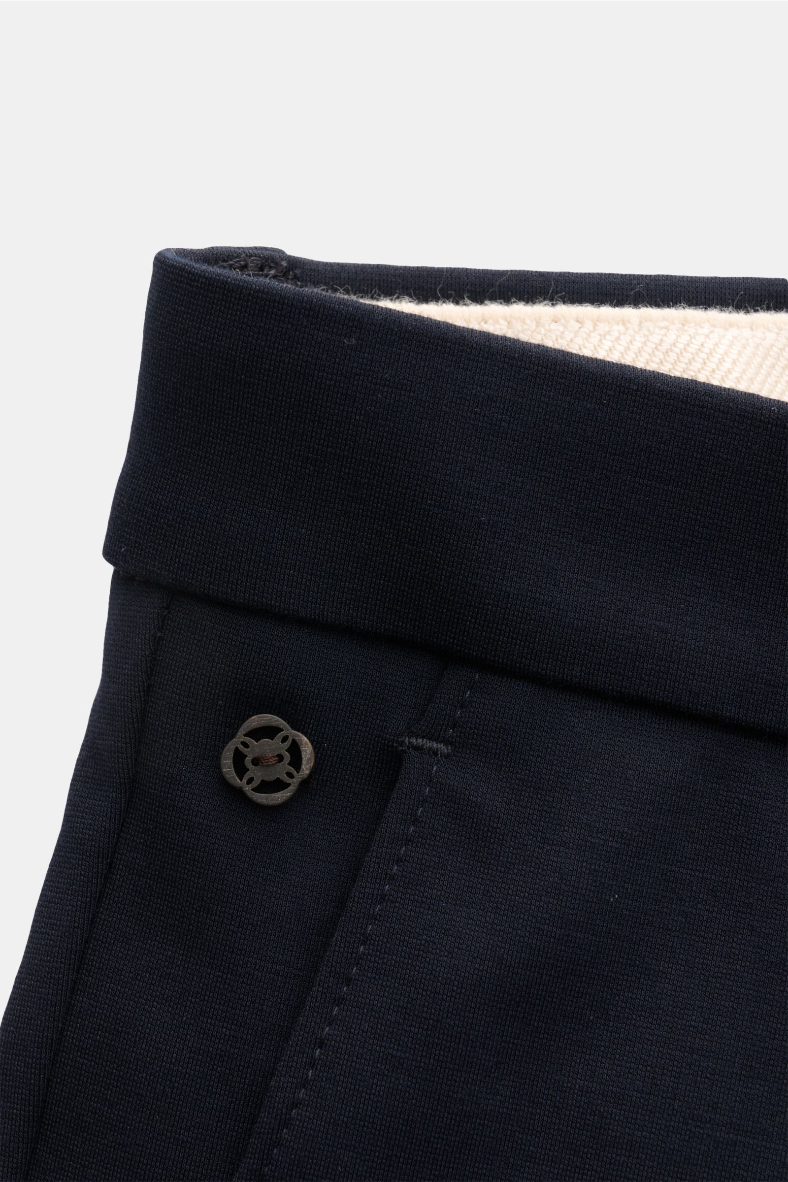 Close-up front view of the waistband of GTA Jersey trousers 'Federico' navy, showcasing elasticated fabric and button details. For casual office looks: The jersey trousers 'Federico' by GTA combine maximum comfort with timeless elegance to make a versatil
