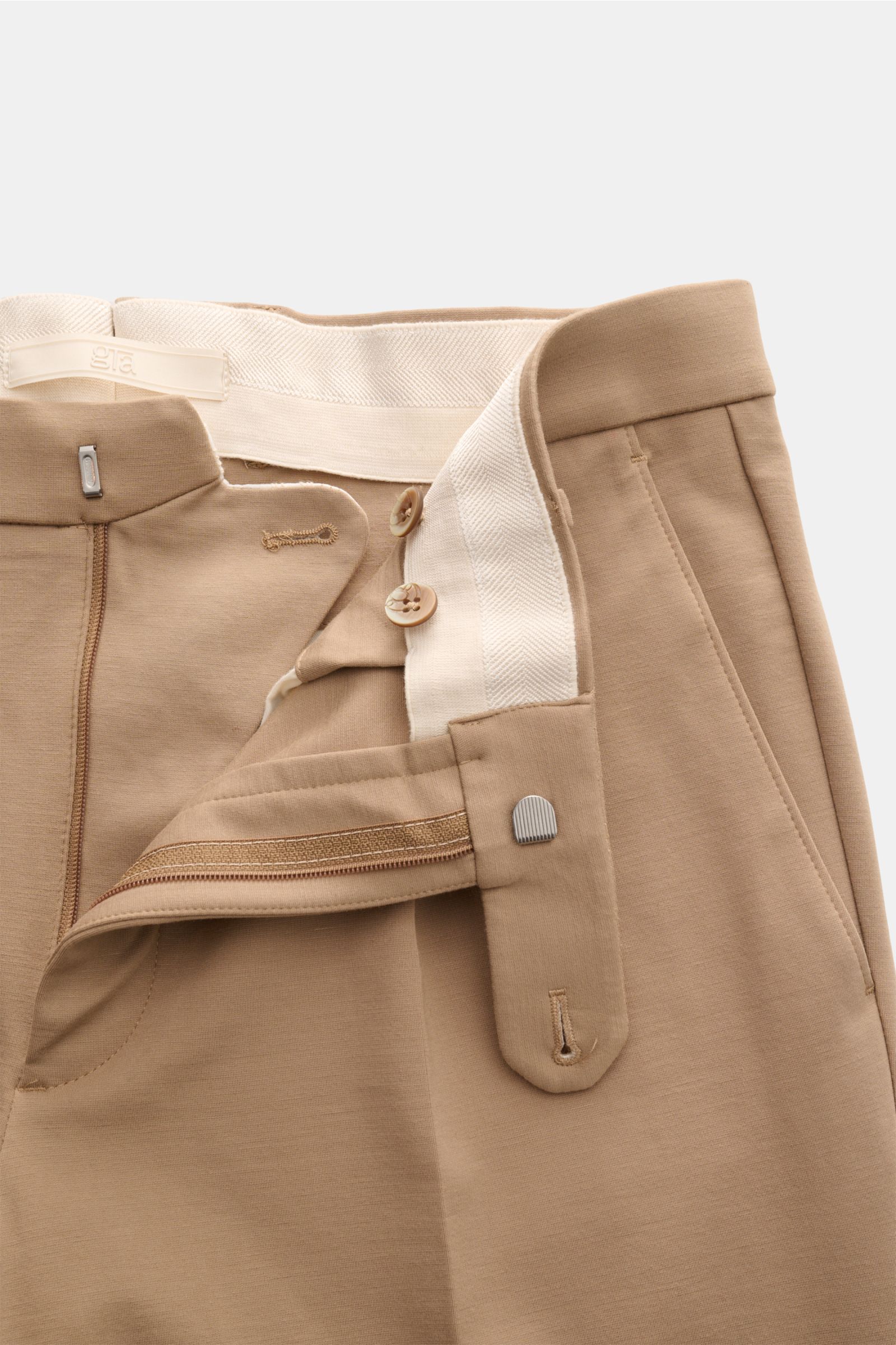 GTA Jersey trousers 'Federico' beige shown from a close-up top-front view, featuring elasticated waistband, zip, button, single pleat, French and jetted back pockets. For casual office looks: The jersey trousers 'Federico' by GTA combine maximum comfort w