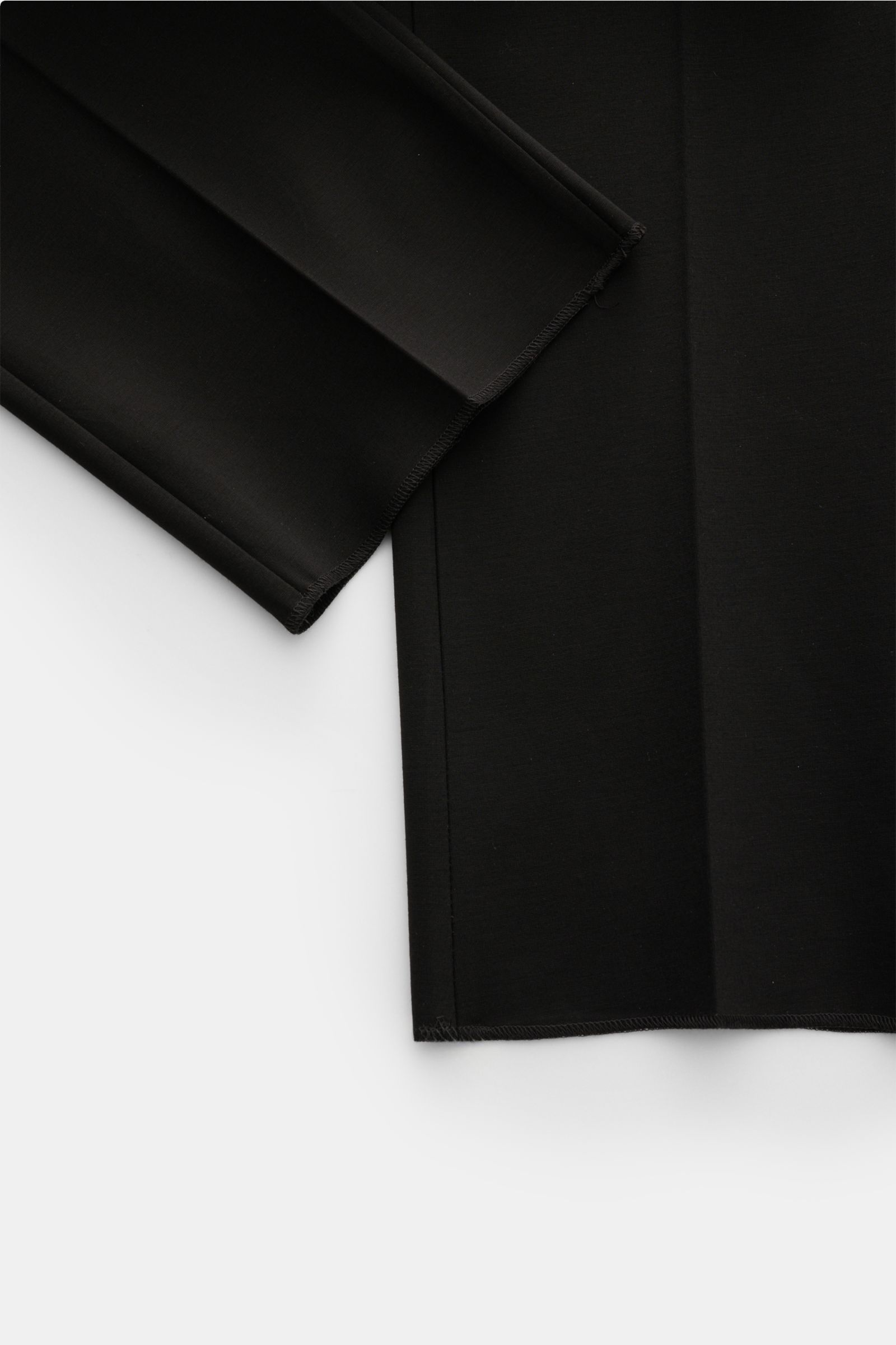 GTA Jersey trousers 'Federico' black shown from above, highlighting soft jersey fabric, elasticated waistband, single pleat, and open hem. For casual office looks: The jersey trousers 'Federico' by GTA combine maximum comfort with timeless elegance to mak