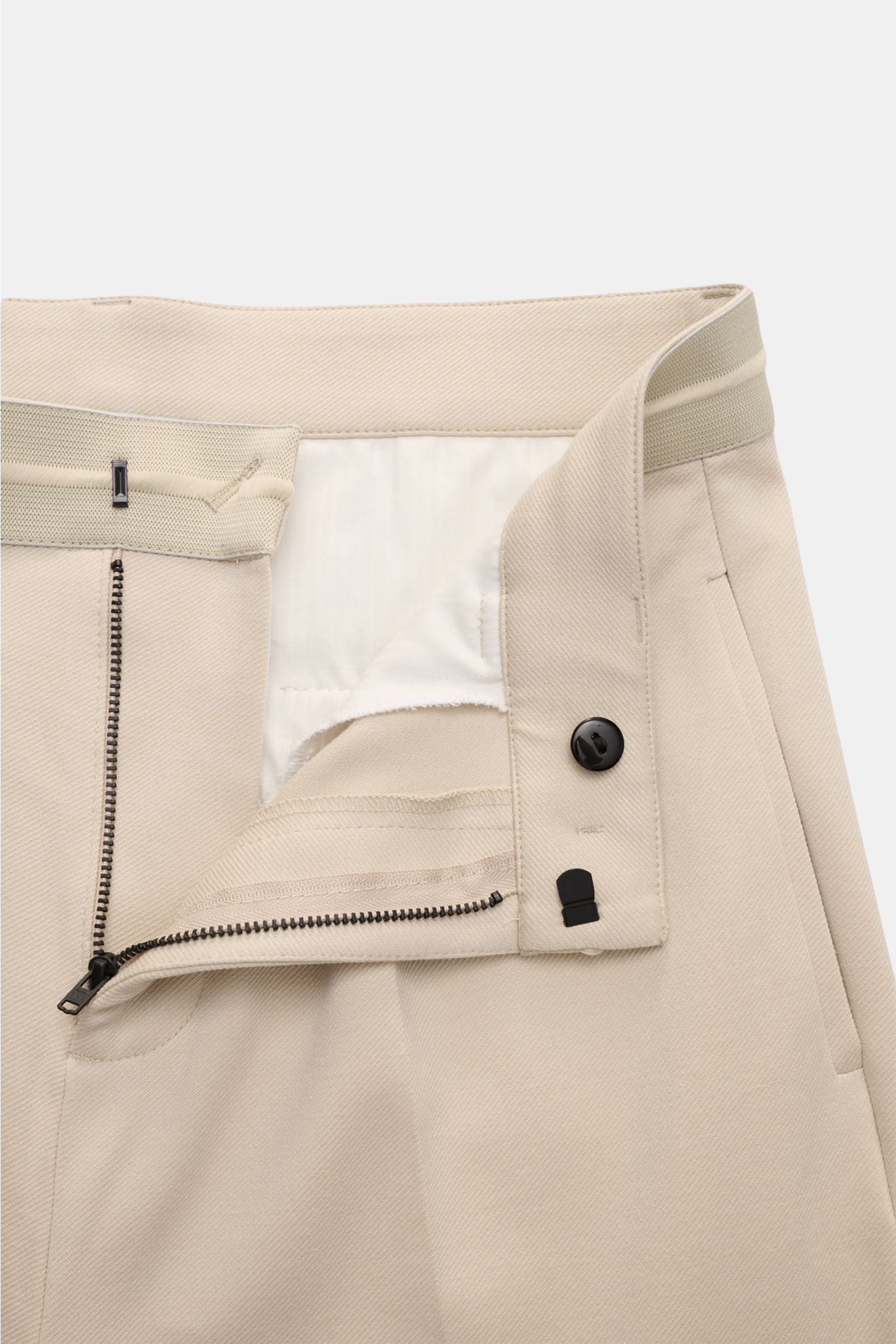 Close-up front view of Kiefermann Jersey trousers 'Hunfrid' sand, showing elastic waistband, zip, hook fastener, and distinctive twill fabric texture. Experience comfort all day long: The jersey trousers 'Hunfrid' by KIEFERMANN combine elegant design with