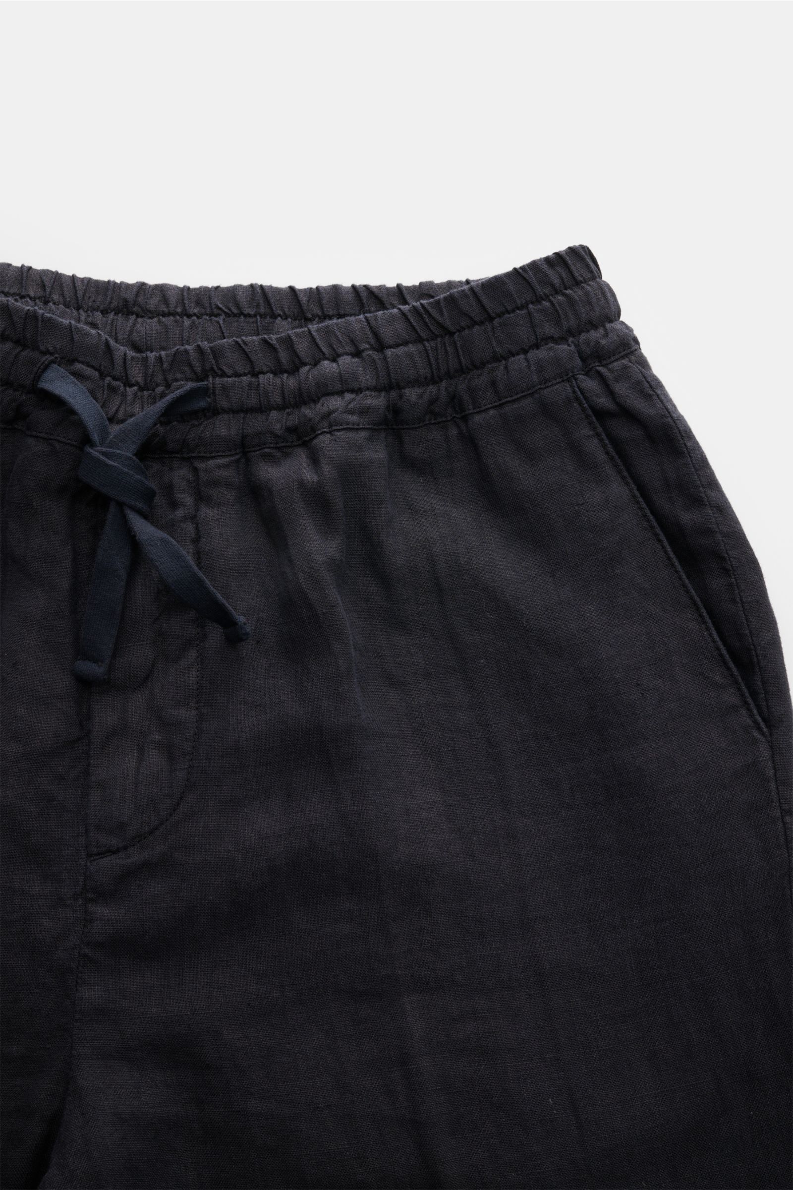 Altea Linen jogger pants 'Mattia' dark navy shown from a close-up top-front perspective, featuring pure linen fabric, elasticated waistband with drawstring, zip fly, French pockets, back pockets with button, tapered fit, regular thigh width, ankle length,