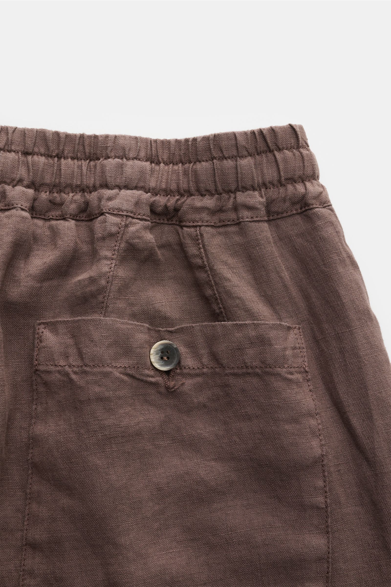 Close-up rear view of Altea Linen jogger pants 'Mattia' grey-brown showing elasticated waistband, buttoned back pocket, pure linen fabric, and relaxed fit. Casual luxury for warm days with features: pure linen, soft feel, lightweight fabric, tapered fit, 